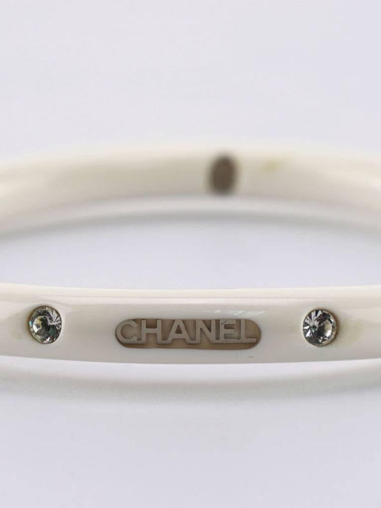 - Year 2000 Chanel white resin with crystal rhinestones bracelet. A summer chic bracelet with bling!

- Made in France. 

- Inner diameter: 6.3 cm (2.5 inches). 

- Outer circumference: 25cm (9.84 inches). 

- Include: Box. 

- Please note that this