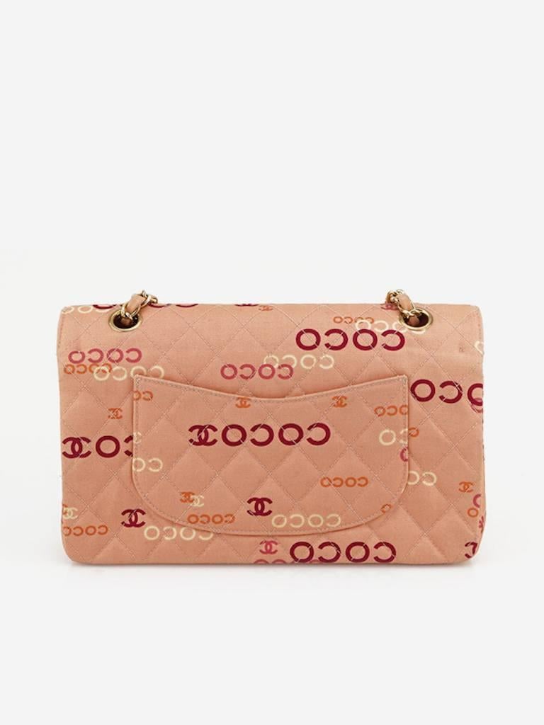 - Chanel pink "Coco" canvas double flap shoulder bag from year 2002 to 2003. Featuring a pink leather gold chain strap, gold "CC" interlock closure, one exterior slip pocket behind, three interior pockets and one zipper pocket.