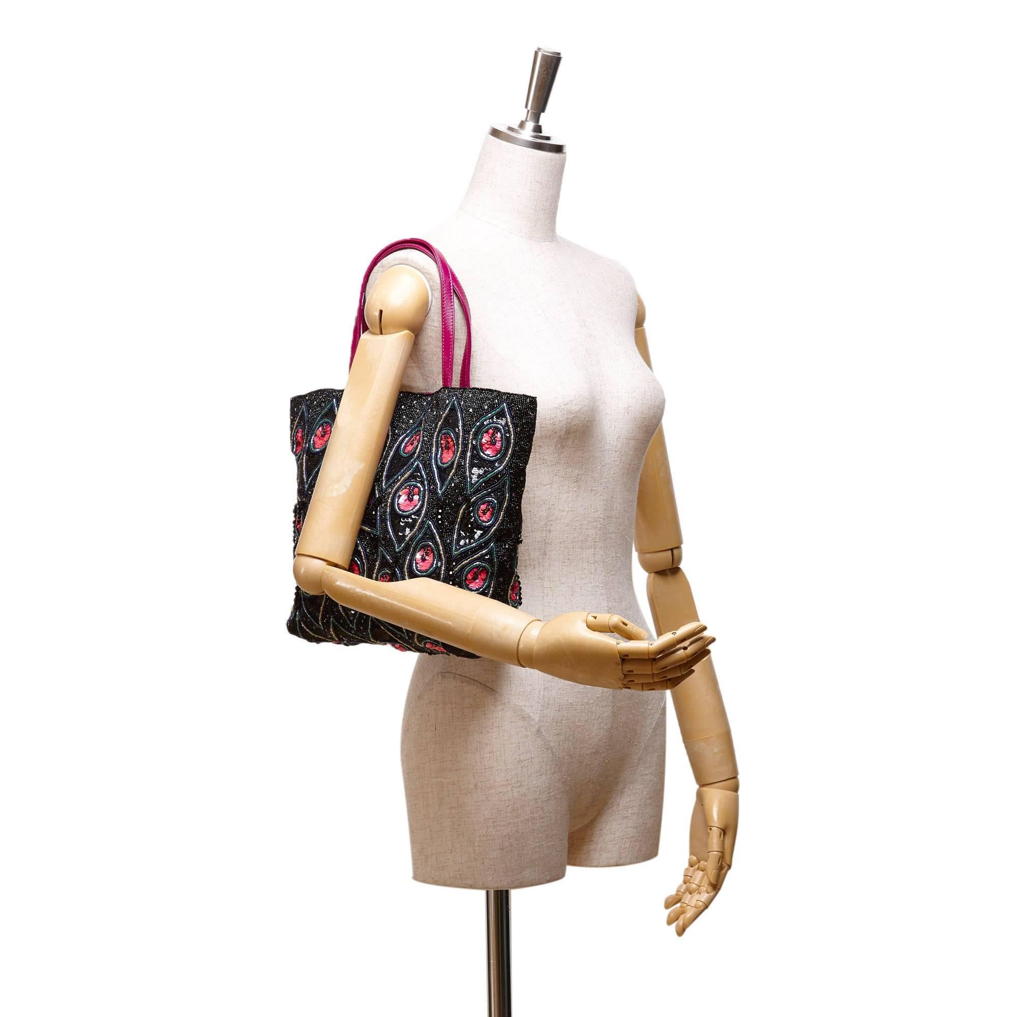 - This Valentino tote bag features a fabric body with multi colour sequin embellishments, a pink leather strap, an open top, and interior zip pocket. This Valentino eyelet pattern tote bag is sexy to carry around town. 

- Made in Italy. 

- Size:
