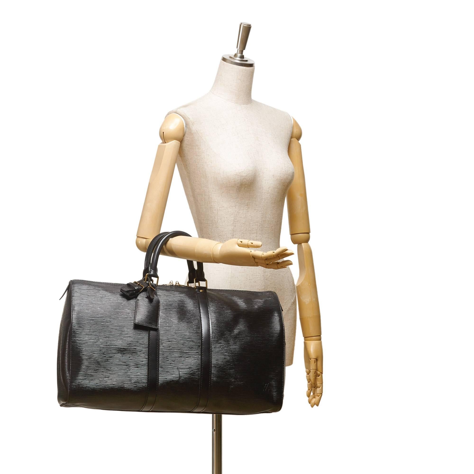 - Vintage 1990 Louis Vuitton Keepall 45 duffle bag features an epi leather body, rolled handles and a top zip closure.

- Made in France. 

- Size: 45cm x 27cm x 20cm. Hand Drop: 11cm. 

- Serial no: VI8910. 

- Includes: Padlock, Key, Name Tag,