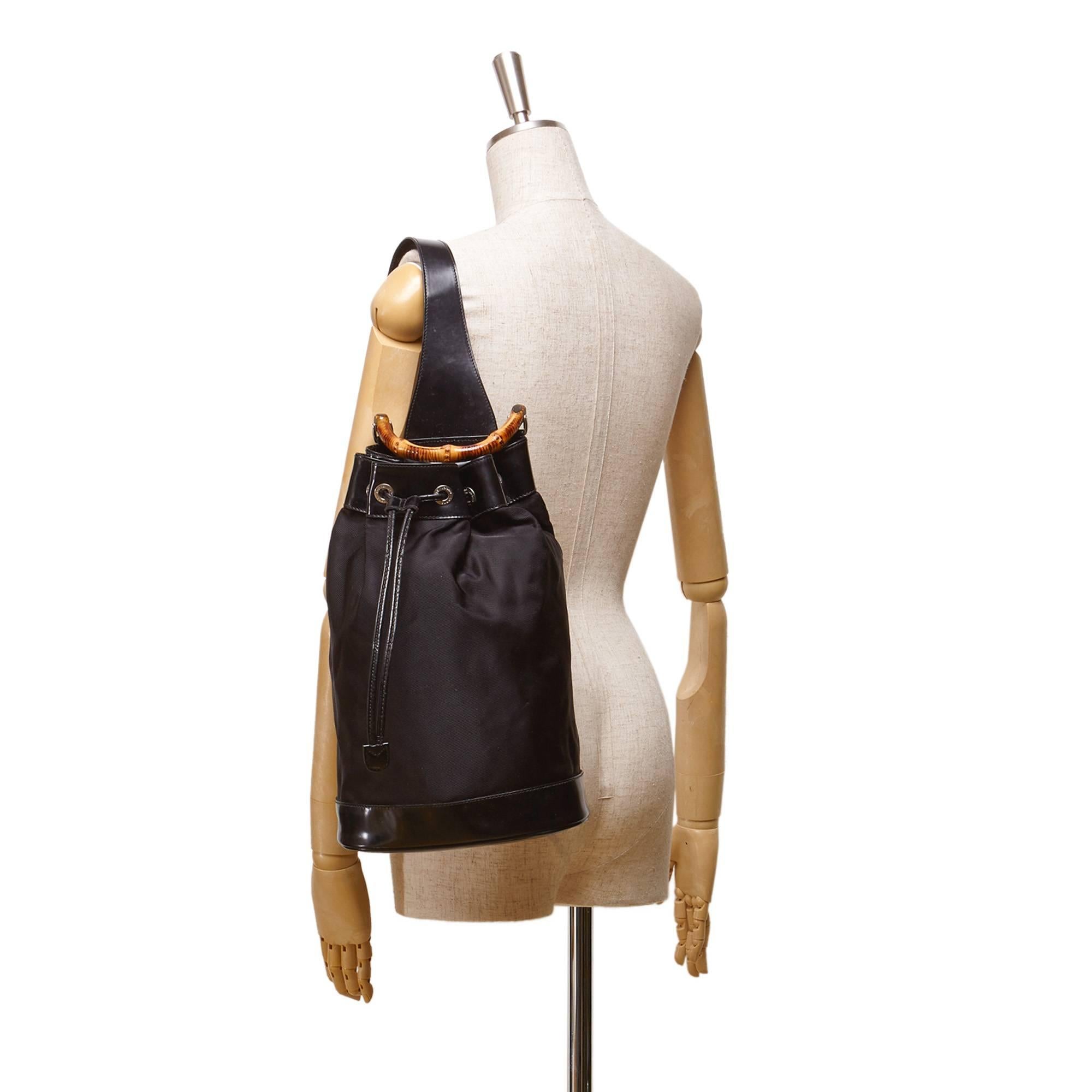 - This Gucci backpack features a black nylon body, a leather trim, an adjustable single shoulder strap, a bamboo handle, a drawstring closure, and a interior zip pocket. A classic and iconic bamboo handle of Gucci. Its still very stylish up till