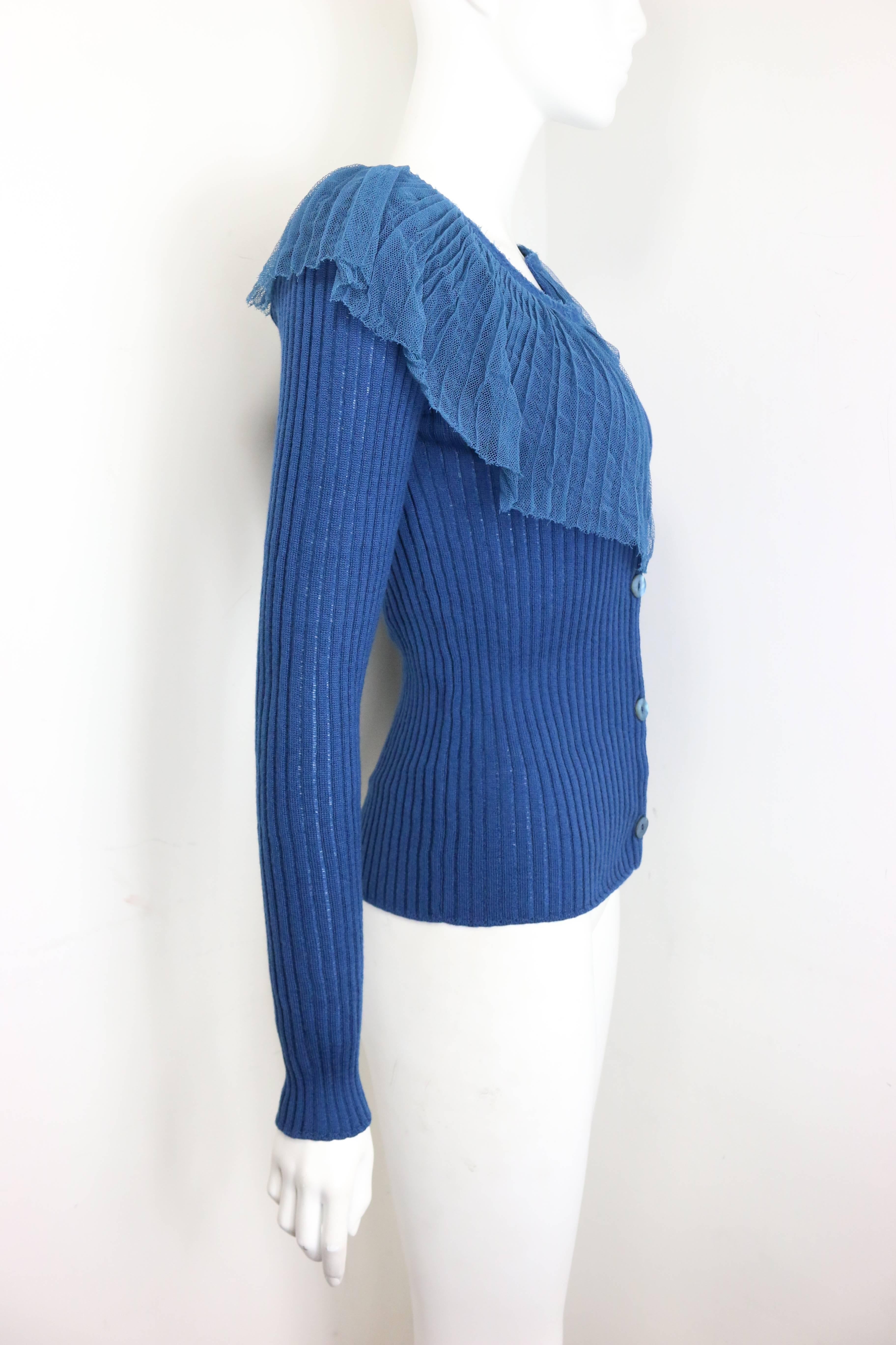 - Jean Paul Gaultier blue wool cardigan sweater. Featuring five buttons closure and asymmetrical lace on top round the neck. 

- Made in Italy. 

- Size XL. 

- 80% Virgin Wool, 13% Cotton, 7% Rayon.

