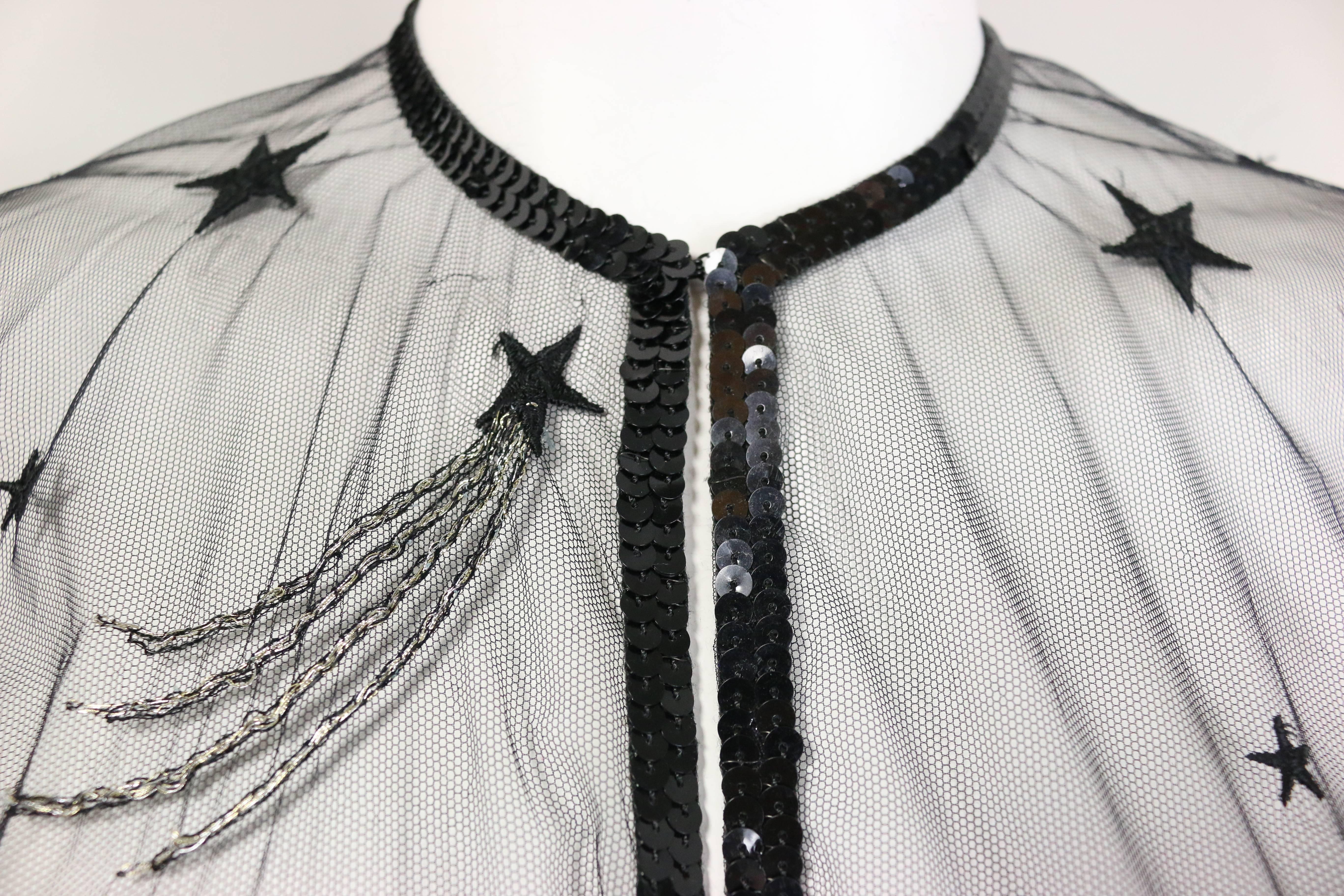 - Vintage Chanel embroidered see through evening dress gown from the late 80s collection. Featuring black sequins piping trims, a black embroidered star with silver linings, and a hook closure. A very classic and one of the early years of Karl