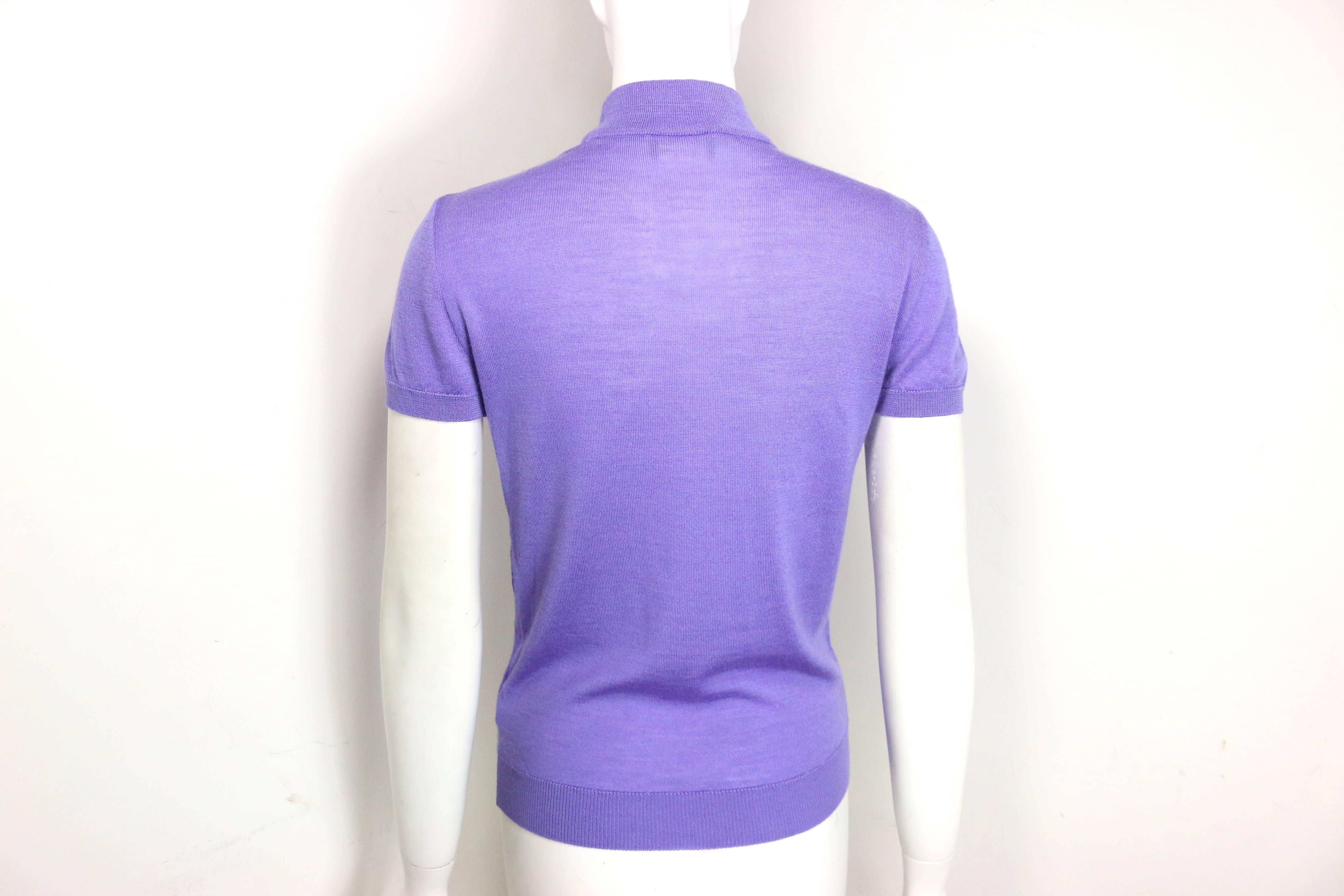 - Vintage 90s Gianni Versace couture purple cashmere and wool mock neck short sleeves pullover top. 

- Made in Italy. 

- Size 42. 

- Bust: 28 inches. Shoulder: 16 inches. Height: 23 inches. 

