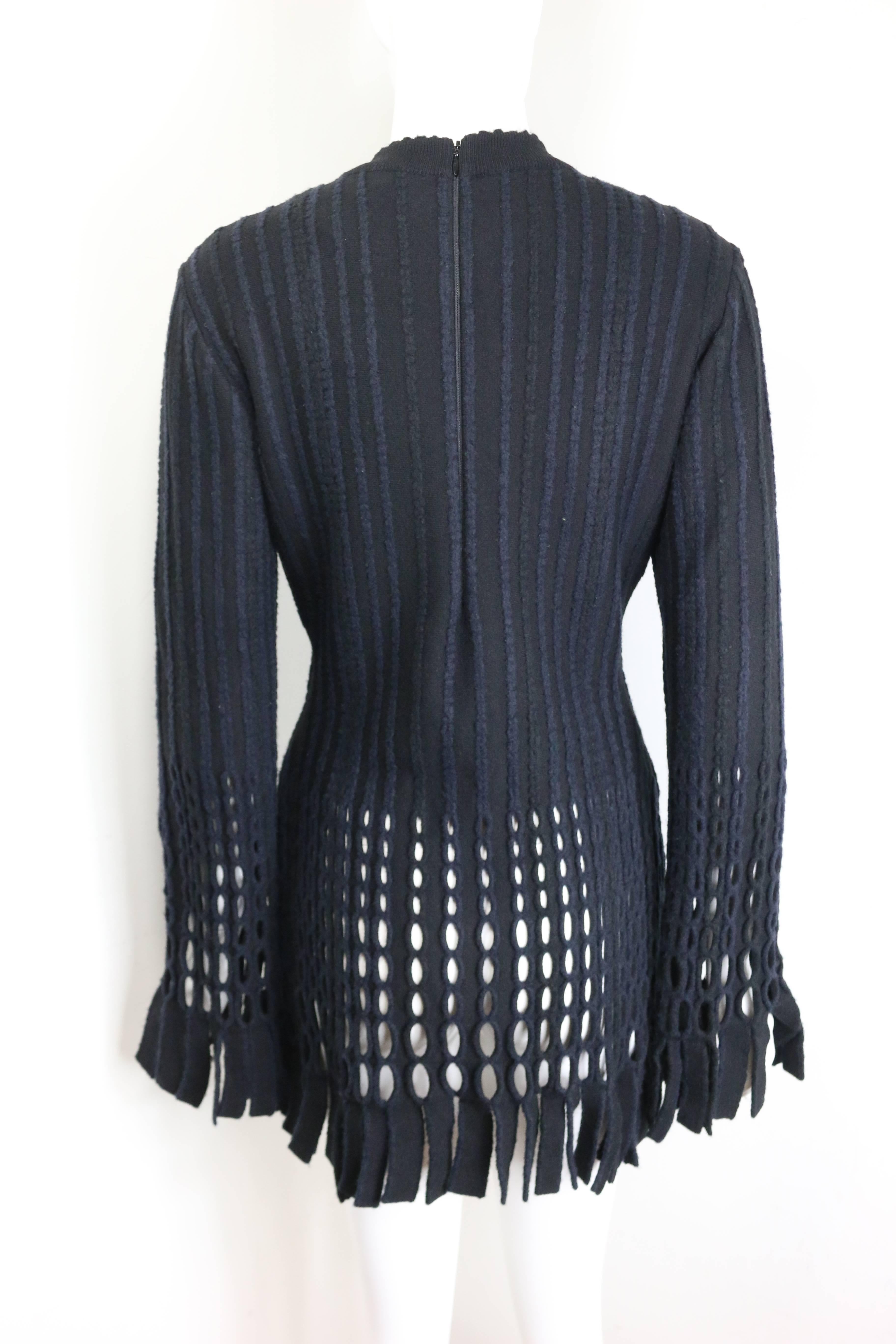 - Vintage 90s Alaia black and navy stripe wool open knit fringe hem dress. Featuring an invisible back zip closure, signature body con stretch fabric fit.  

- Made in France. 

- Size L 
 
- Bust: 34 inches. Shoulder: 17 inches. Sleeves: 26 inches.