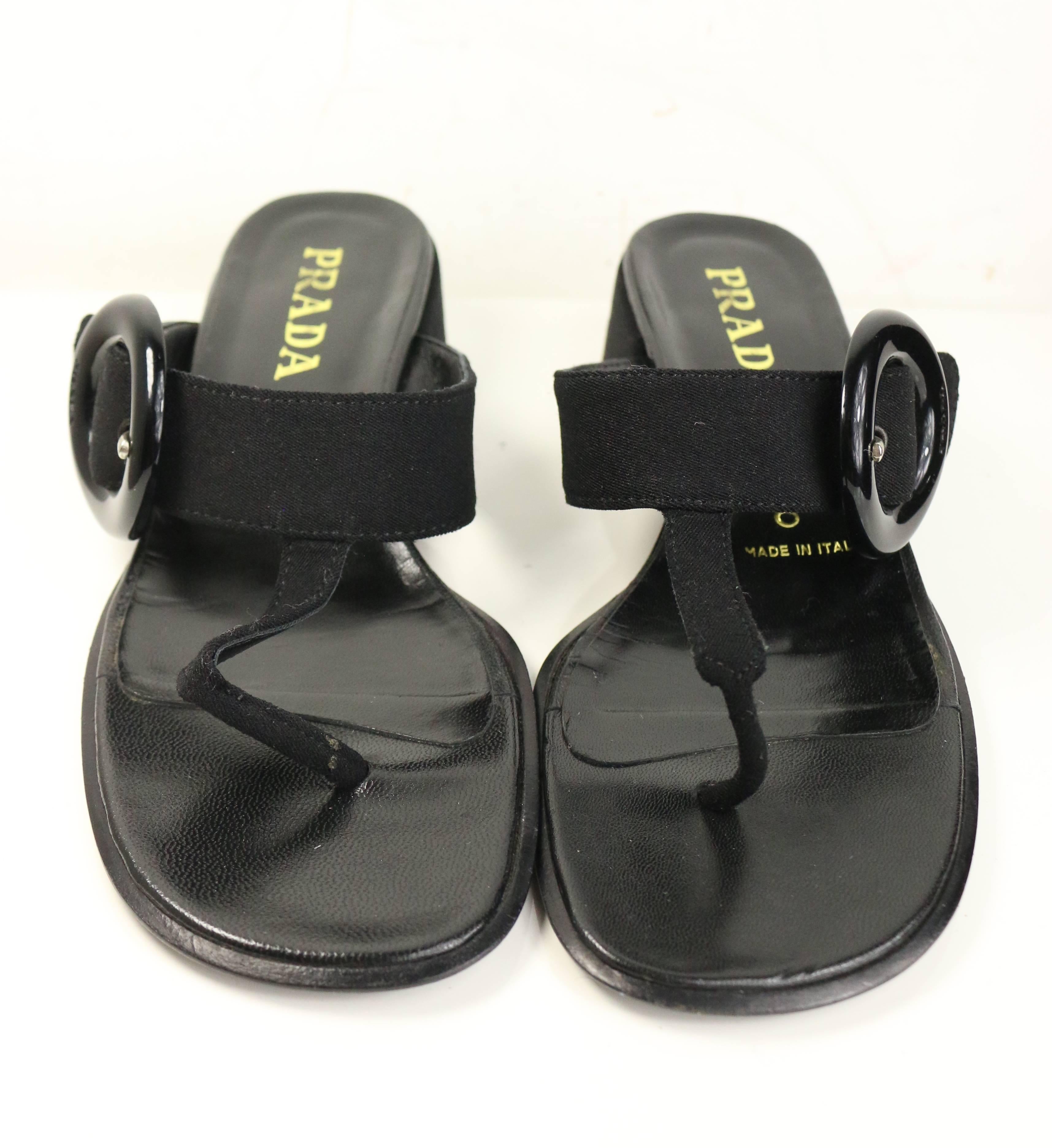 - Vintage 90s Prada black retro style T - shape sandals. Featuring a black vinyl buckle on the side. Looks super retro and chic! 

- Made in Italy. 

- Size 37.5. 

