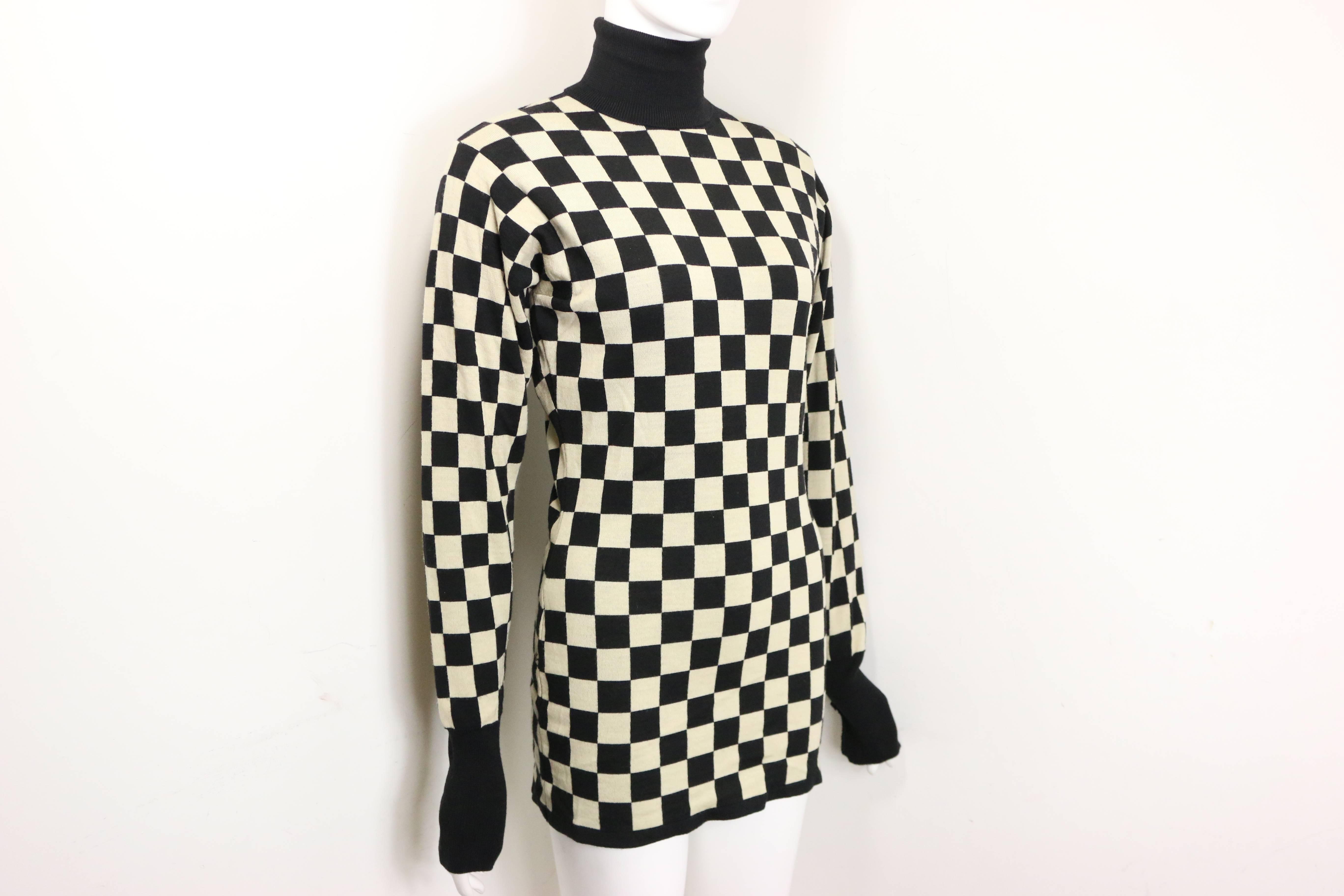 - Vintage 90s Moschino black and white wool check pattern turtleneck pullover sweater. 

- Made in Italy. 

- Shoulder: 16 inches. Bust: 32 inches. Height: 28 inches. Sleeves: 26 inches. 

- 100% Wool. 

