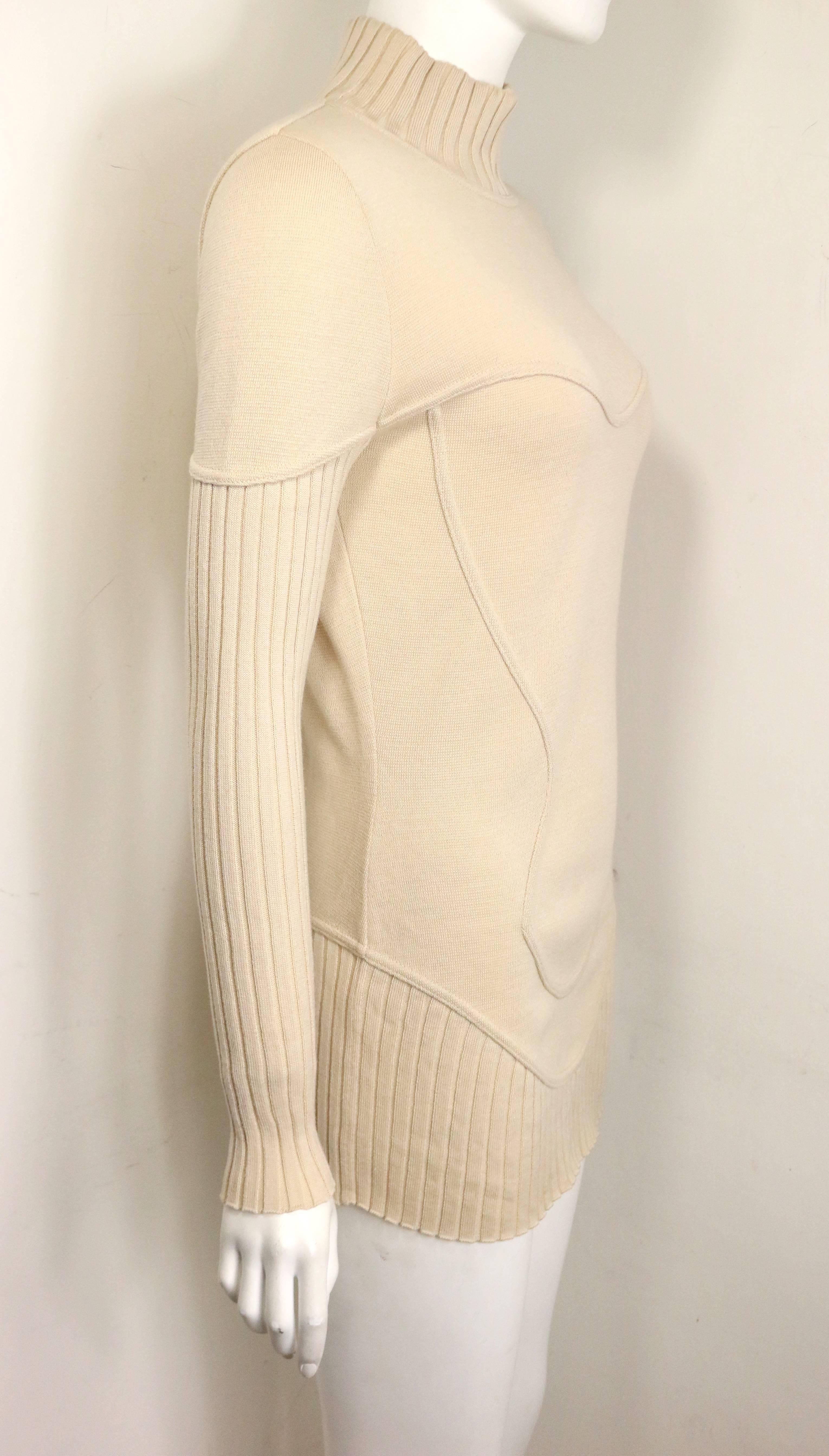 - Vintage 90s Mugler by Thierry Mugler light beige mock neck wool pullover sweater. Featuring ribbed neck, sleeves and hem. A very details design sweater. 

- Made in Italy. 

- Size 42. 

- 100% Wool. 

- Bust: 32 inches. Shoulder: 14inches.