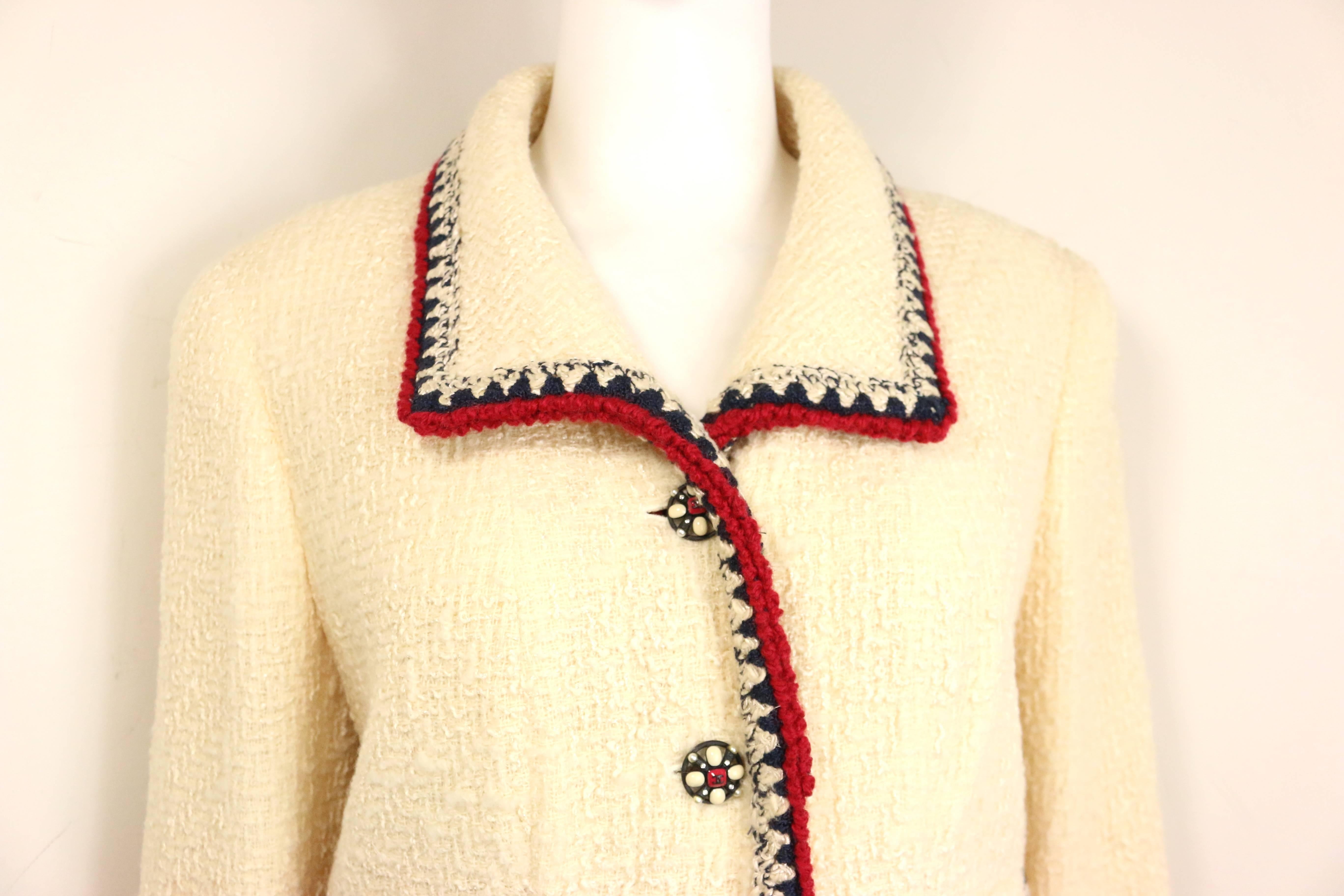 -  Chanel white wool tweed with black and red piping trim jacket from 2006 fall collection. Its a very classic Chanel tweed jacket. 

- Four front pockets with clover 