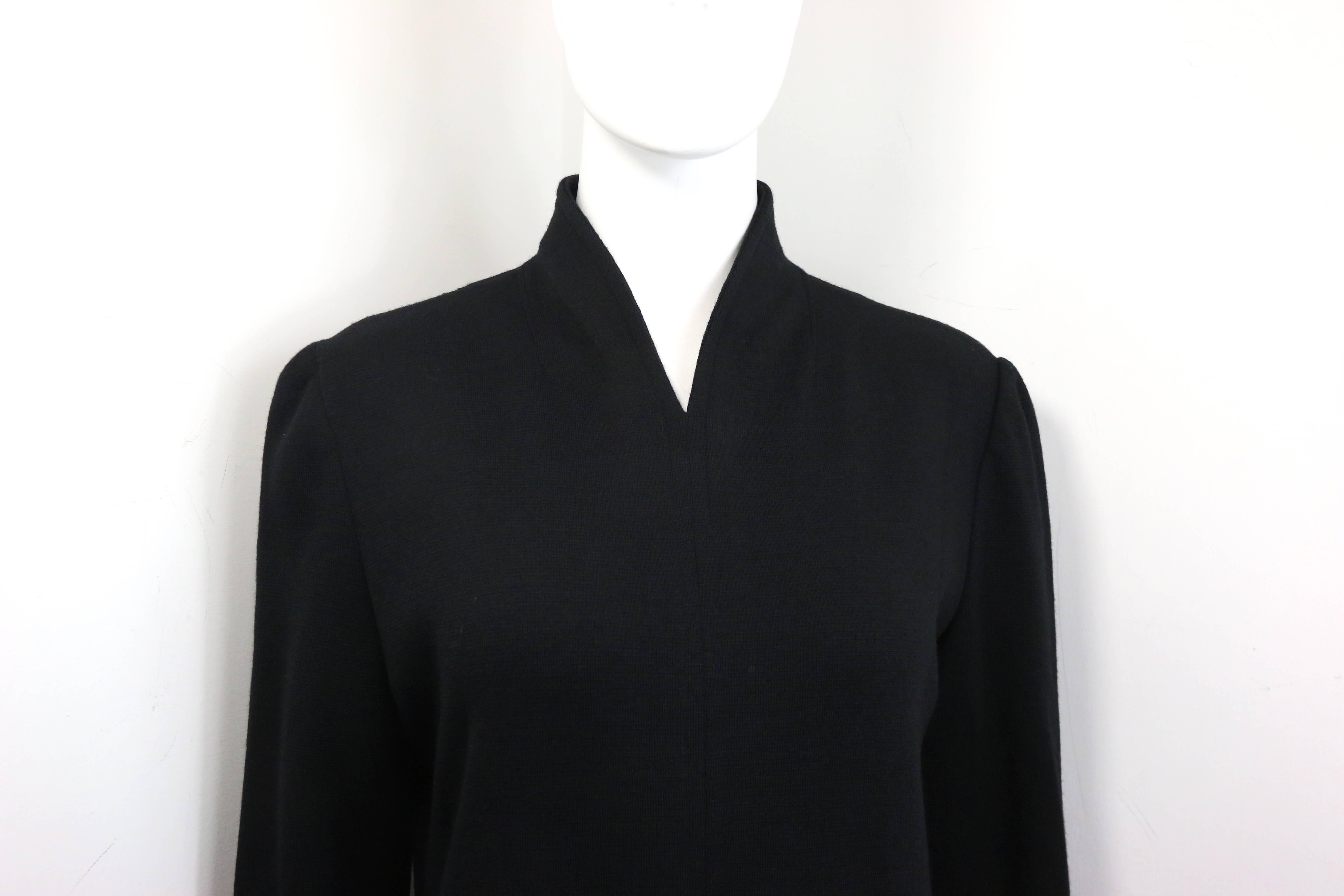 - Vintage 90s Celine black wool long dress. 

- V-Shaped Neckline. 

- Slit hem in front.

- Back zip closure. 

- Size 40. 

- Shoulder: 15 inches. Bust: 32 inches. Height: 51 inches. Sleeve: 24 inches. 

- 100% Pure wool. 

- 