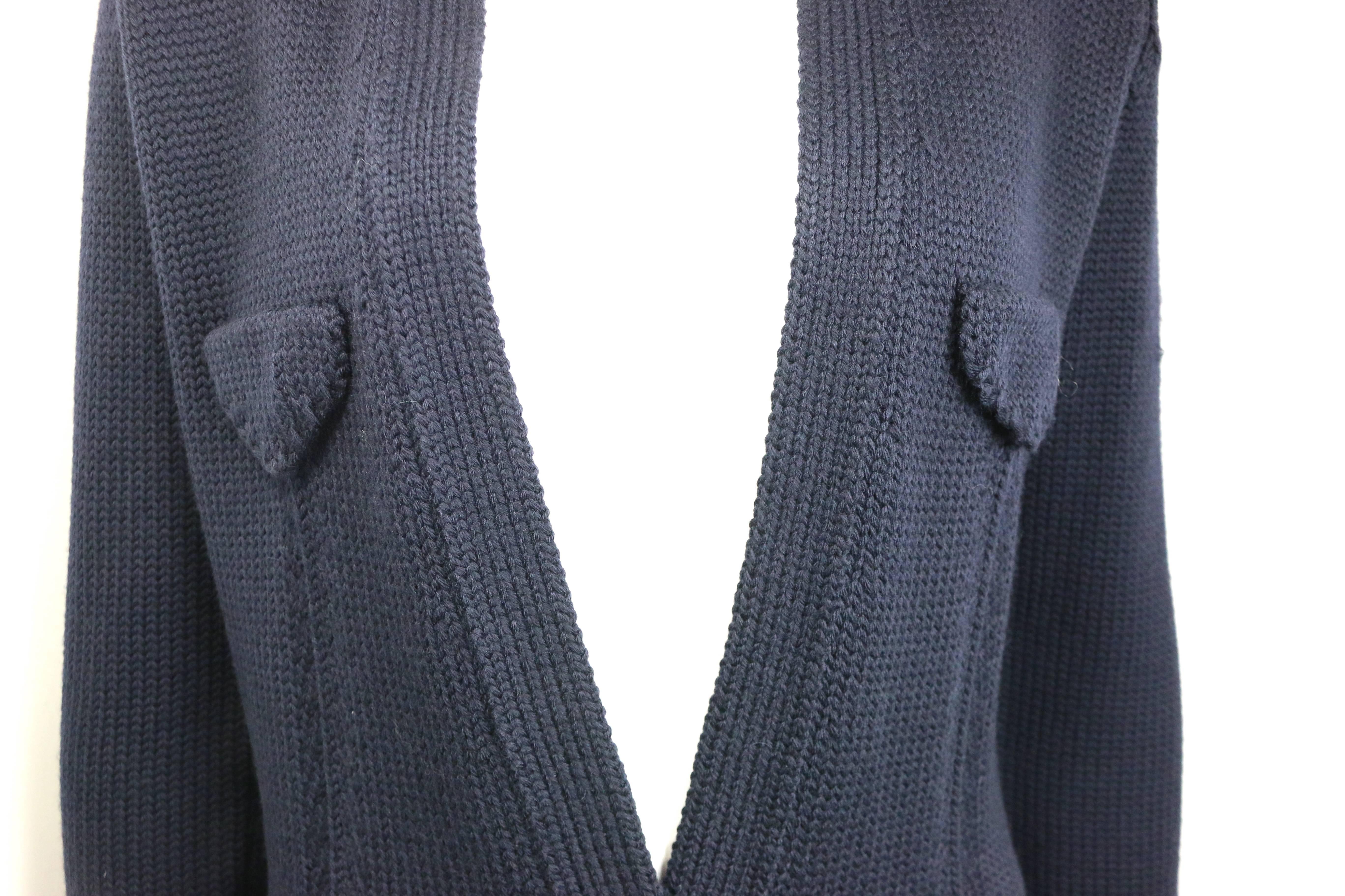 - Vintage Gucci by Tom Ford dark navy wool knitted cardigan jacket from Fall 1996 collection. 

- Mandarin collar. 

- Epaulette Shoulder. 

- Four front pockets. Two flap open pockets. 

- Two buttons closure. 

- Shoulder Pad. 

- Size L. 

- 100%