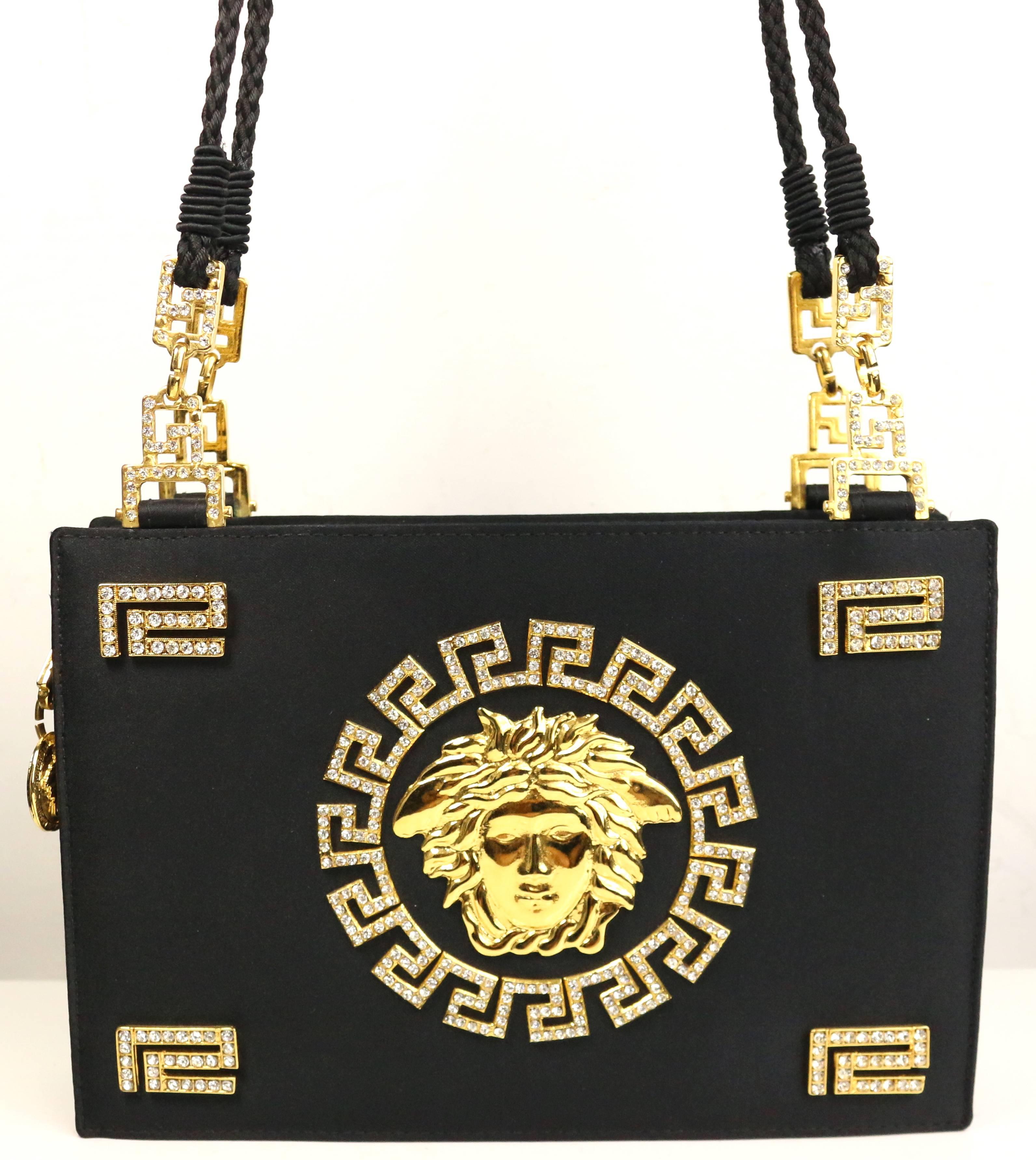 - Embedded iconic gold and rhinestones Medusa logo. 

- Made in Italy. 

- Length: 9 inches. Height: 6 inches. Width: 2 inches. Shoulder Drop: 21 inches. 
