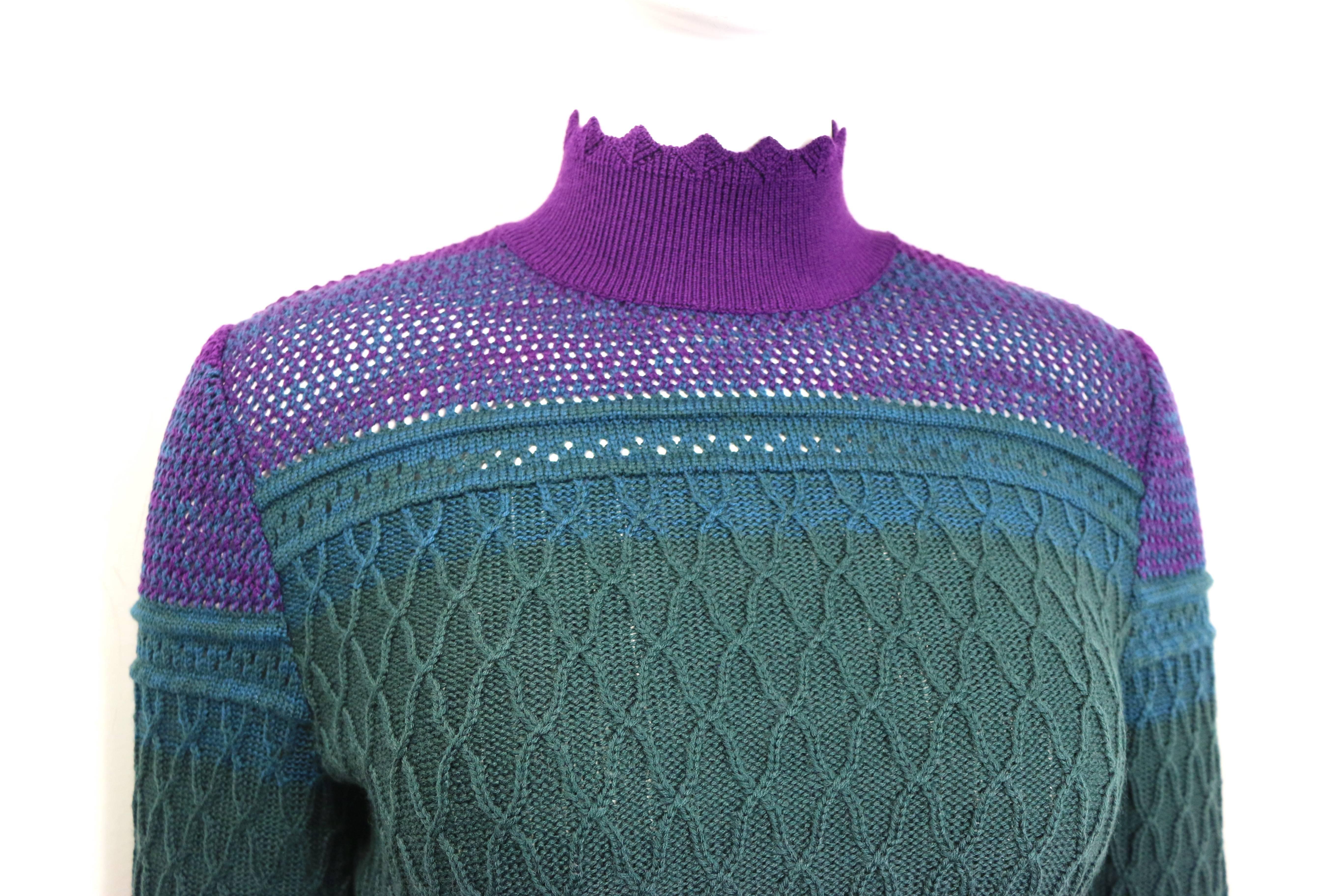 - Vintage Christian Lacroix purple/green/blue knitted pattern wool mock neck top from 1994 collection. 

- Round edge on the neck, hem and cuff. 

- Purple ribbed neck.

- Back zip closure. 

- Size M. 

- Shoulder: 14 inches. Bust: 30 inches.