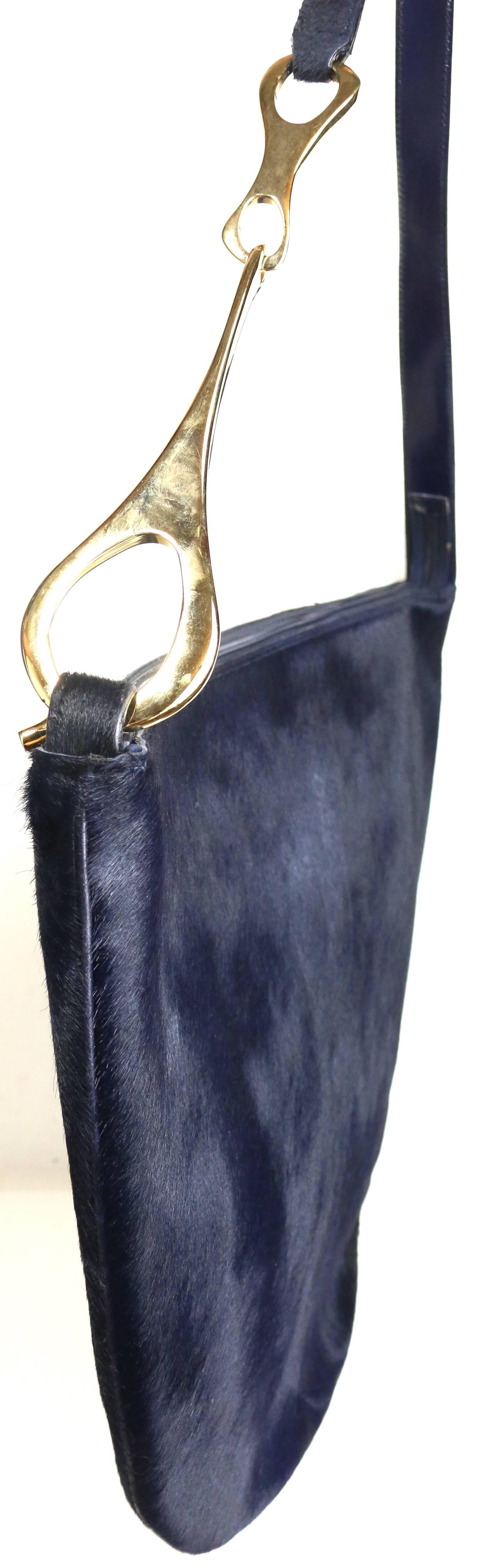 - Gucci by Tom Ford navy pony hair jumbo shoulder bag from Fall 1996 collection. 

- Half circle shape. 

- The signature Fall 1996 collection gold toned metal buckle shoulder strap.

- Gold toned metal 
