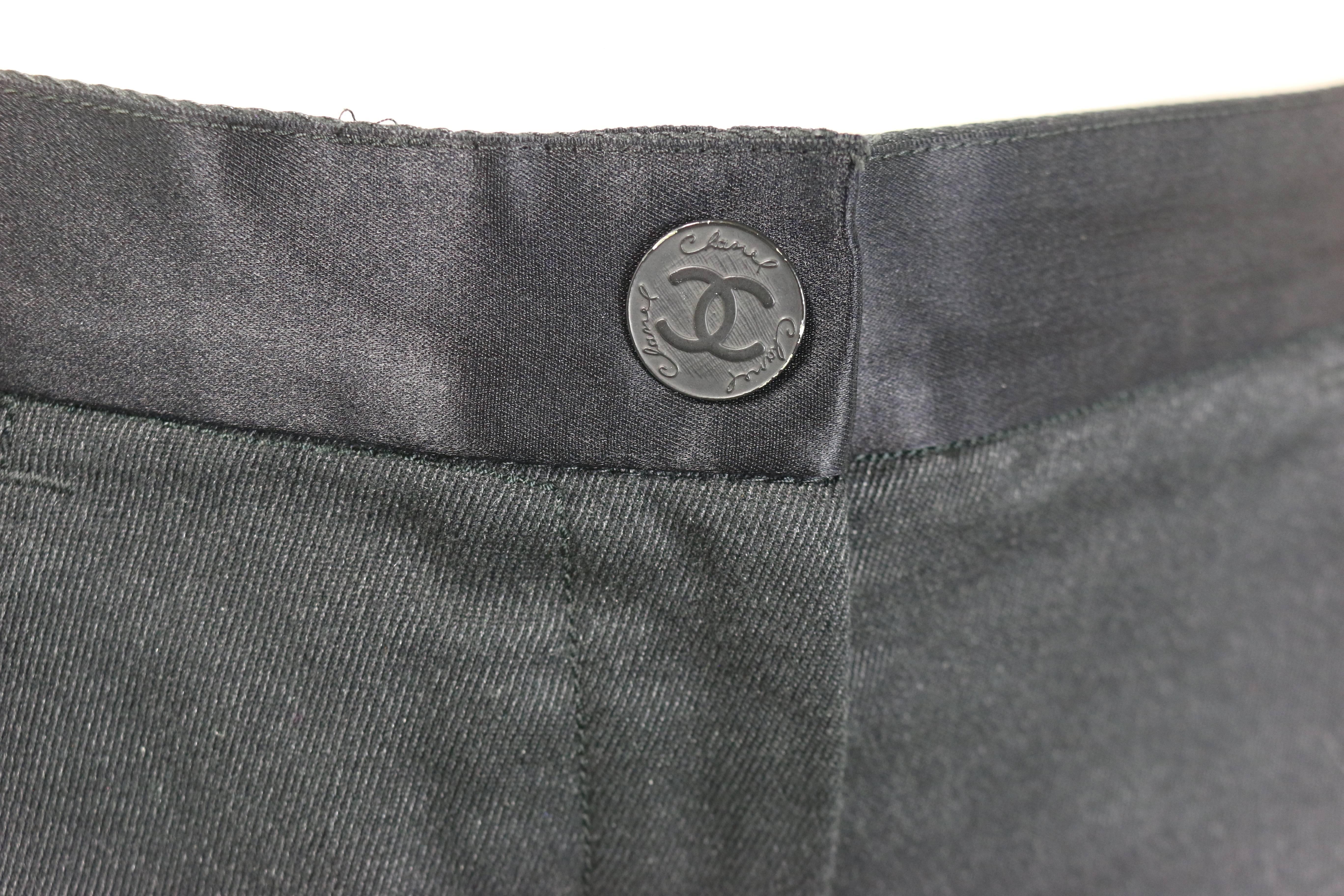 - Chanel black jeans with silk tied bows. 

- Silver stripe pattern. 

- Silk waist Trim with 