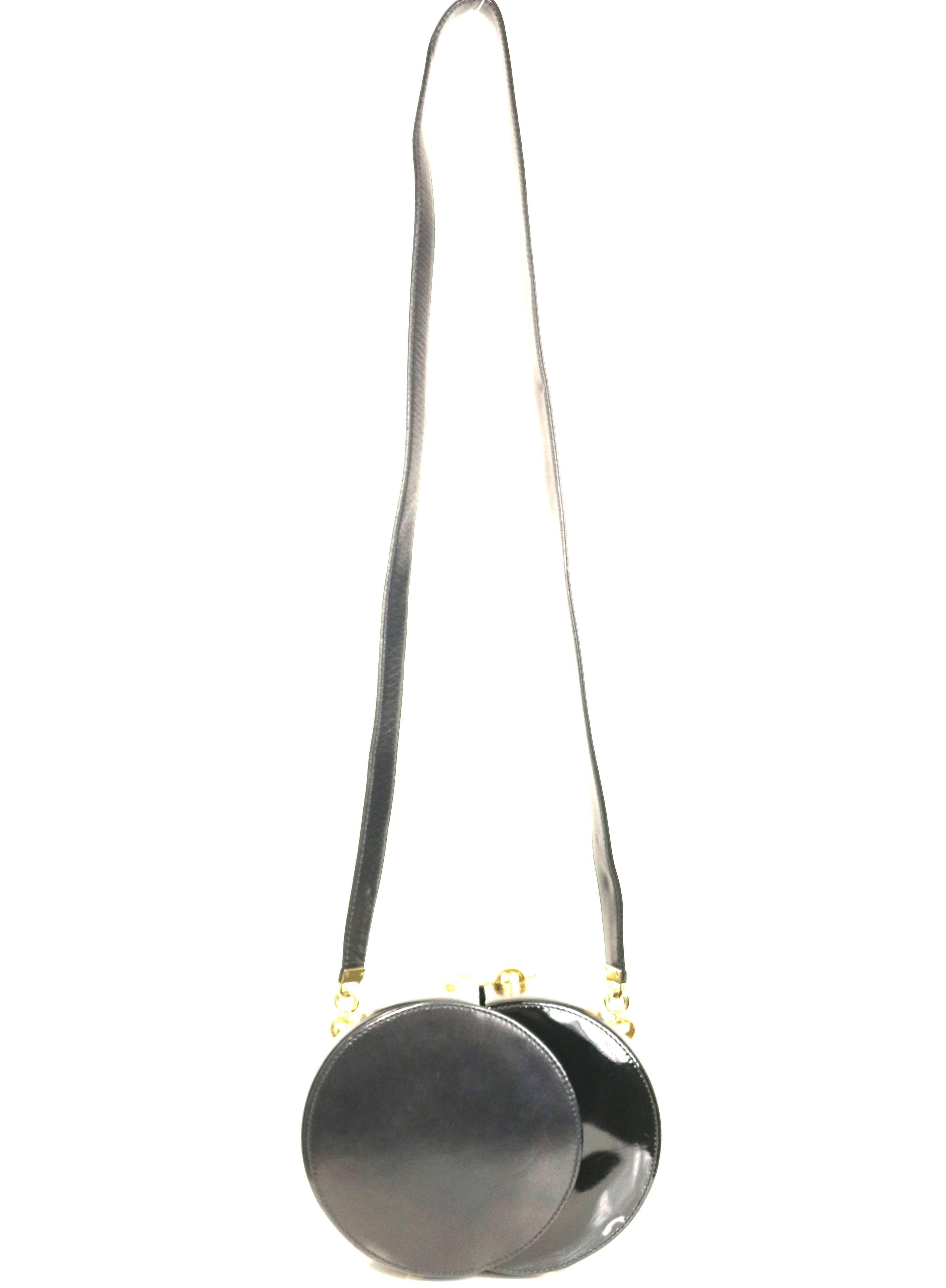 - Vintage 80s Franco Bellini black lambskin / patent leather round shoulder bag. 

- Featuring a gold toned hardware snap button closure. 

- Leather strap. 

- Gold toned studs on the bottom. 

- Diameter: 7.5 inches. Each circle diameter: 5.5