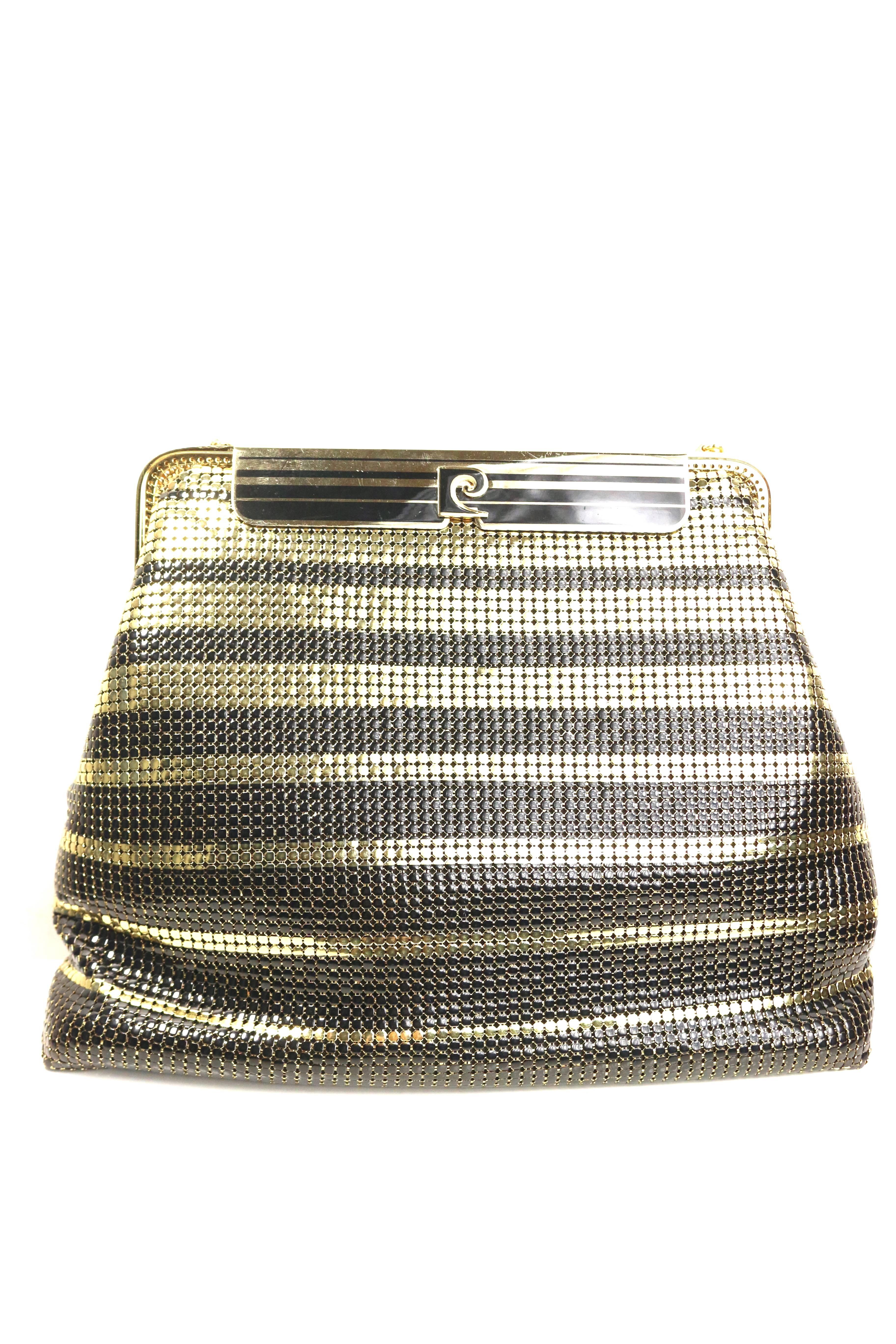 - One of a kind vintage 80s Pierre Cardin black and gold plated stripe sequins shoulder bag/clutch. 

- Gold plated with logo flap closure. 

- Gold plated shoulder strap. 

- Two interior satin open pocket. 

- Height: 7 inches. Length: 9 inches.