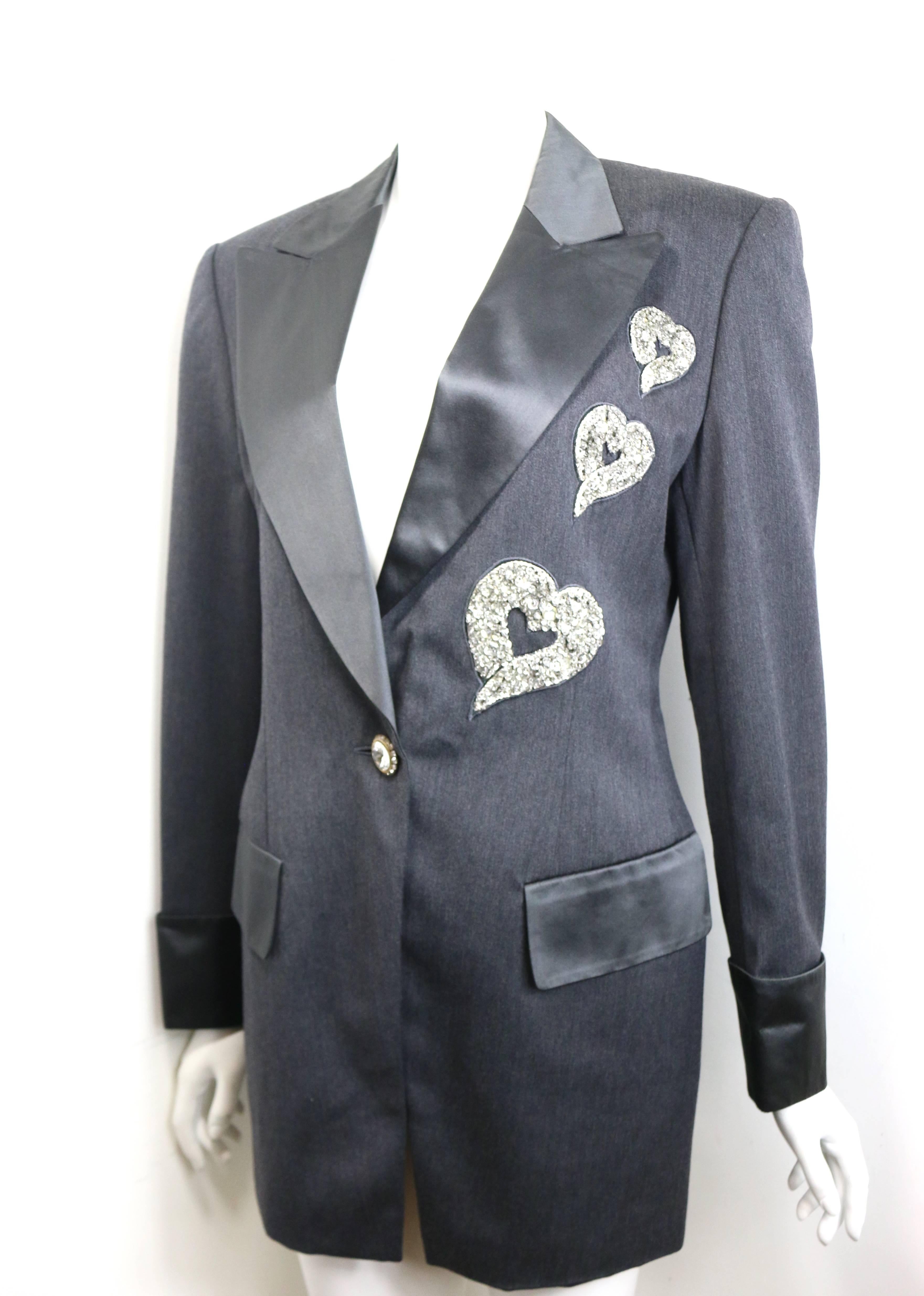 - Vintage 80s Escada by Margaretha Ley grey wool jacket. 

- Featuring silk piping lapel, cuffs and pocket flaps. 

- Three different sizes of embroidered silver sequins hearts. 

- Front and cuff gold toned rhinestones buttons closure. 

- Size 36.