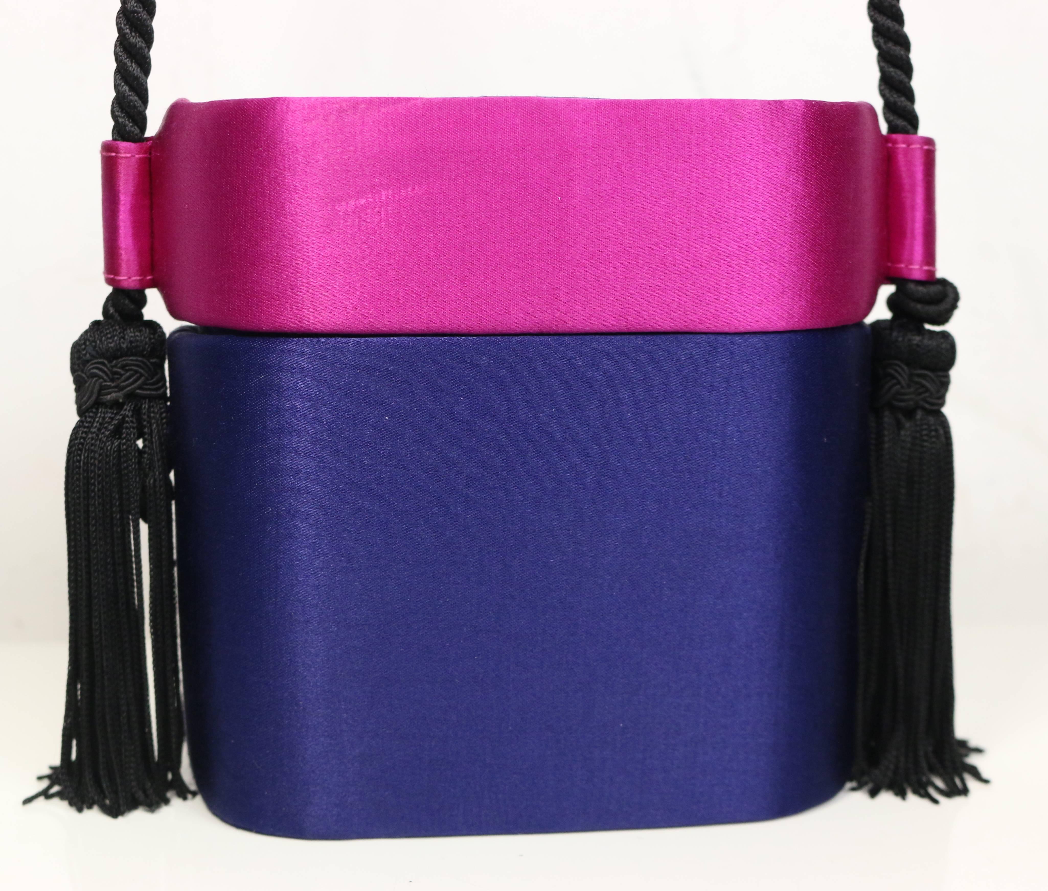 - Vintage 80s Escada blue and pink silk box clutches shoulder bag. Rare and one of a kind!!!

- Black tassel shoulder rope strap. 

- Pink silk top closure. 

- Interior open pocket. 

- Length: 5 inches. Height: 5 inches. Width: 2.5 inches.