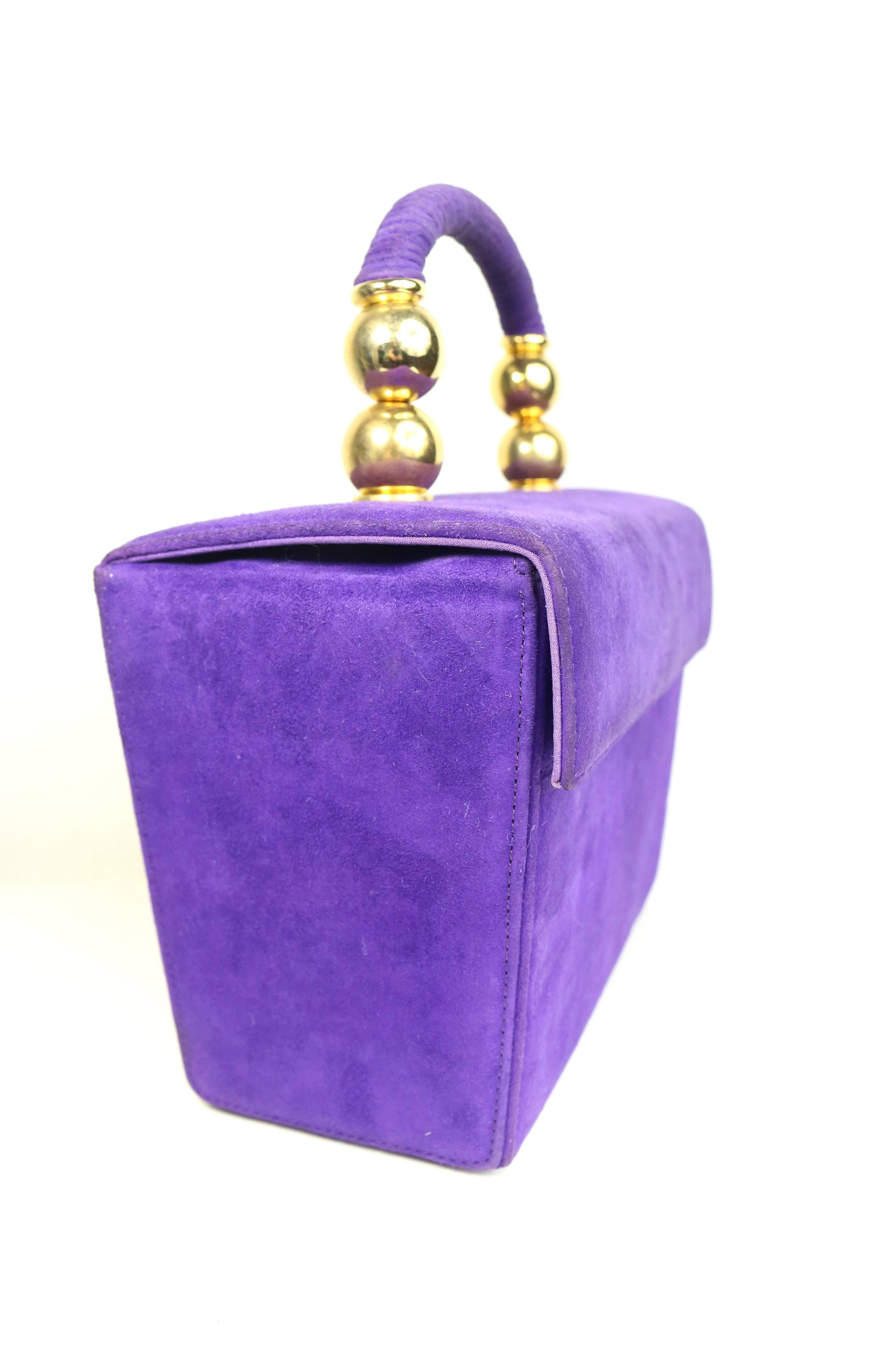 - Vintage 80s Baldinini purple suede box handbag. This bag was exclusive for Romano. 

- Featuring two rounds gold toned hardware with purple suede handle 

- Small flap with snap button closure. 

- Four gold toned studs at the bottom. 

- Interior