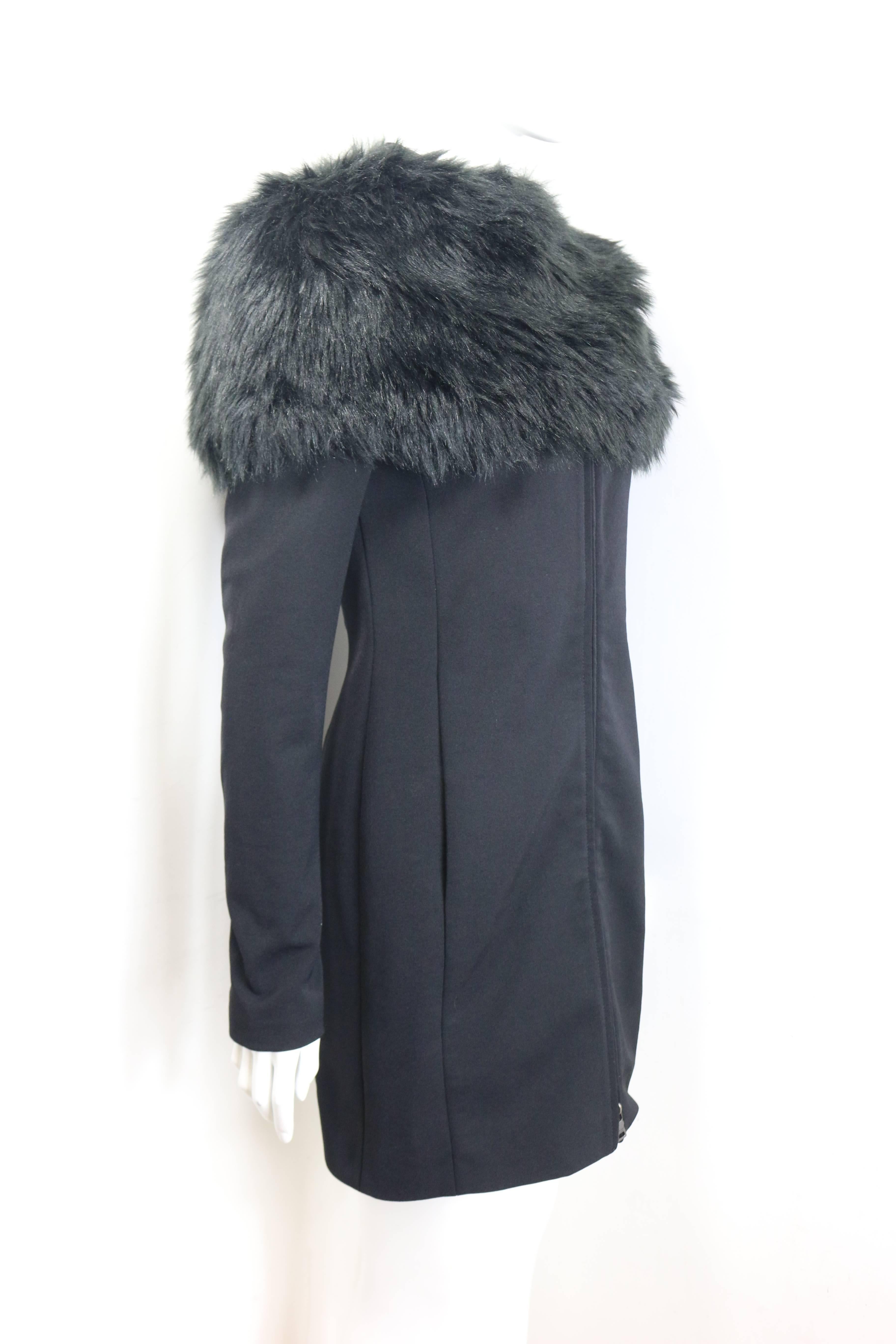- Prada black nylon knee length jacket. 

- Mandarin Collar. 

- Two way zippers closure. 

- Side pockets. 

- Detachable black faux fur. 

- Size 38. 

- Outer Shell: 70% Nylon, 24 % Polyester, 4% Others. Lining: 57% Viscose, 43% Polyester.