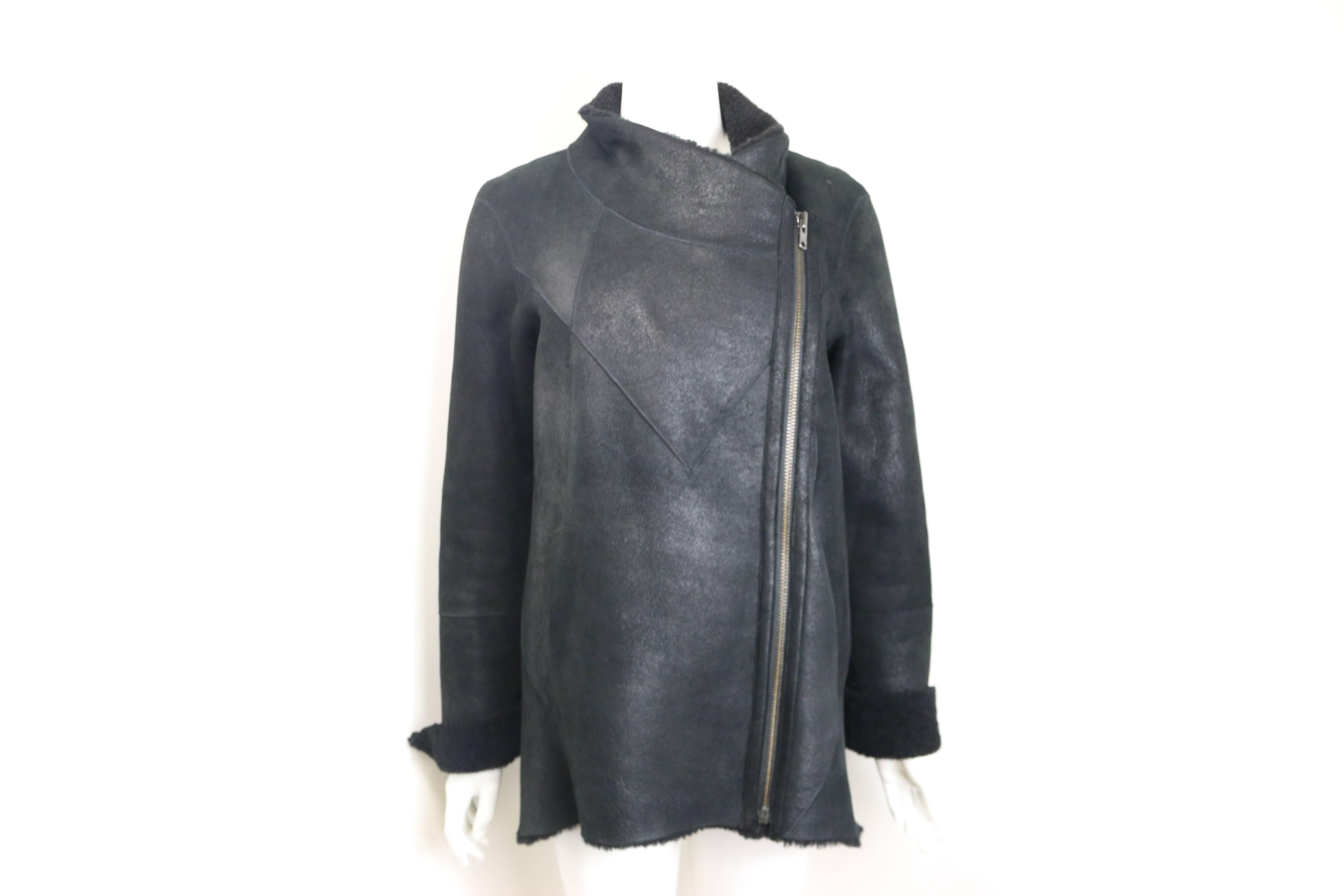 - Helmut Lang black lambskin leather wrecked shearling jacket. 

- Angled Seaming in front and back. 

- Funnel neck unzips to turn-back collar with off-center zip front closure. 

- Zip closure cuffs.  

- Side pockets. 

- Fur origin: Spain. 

-
