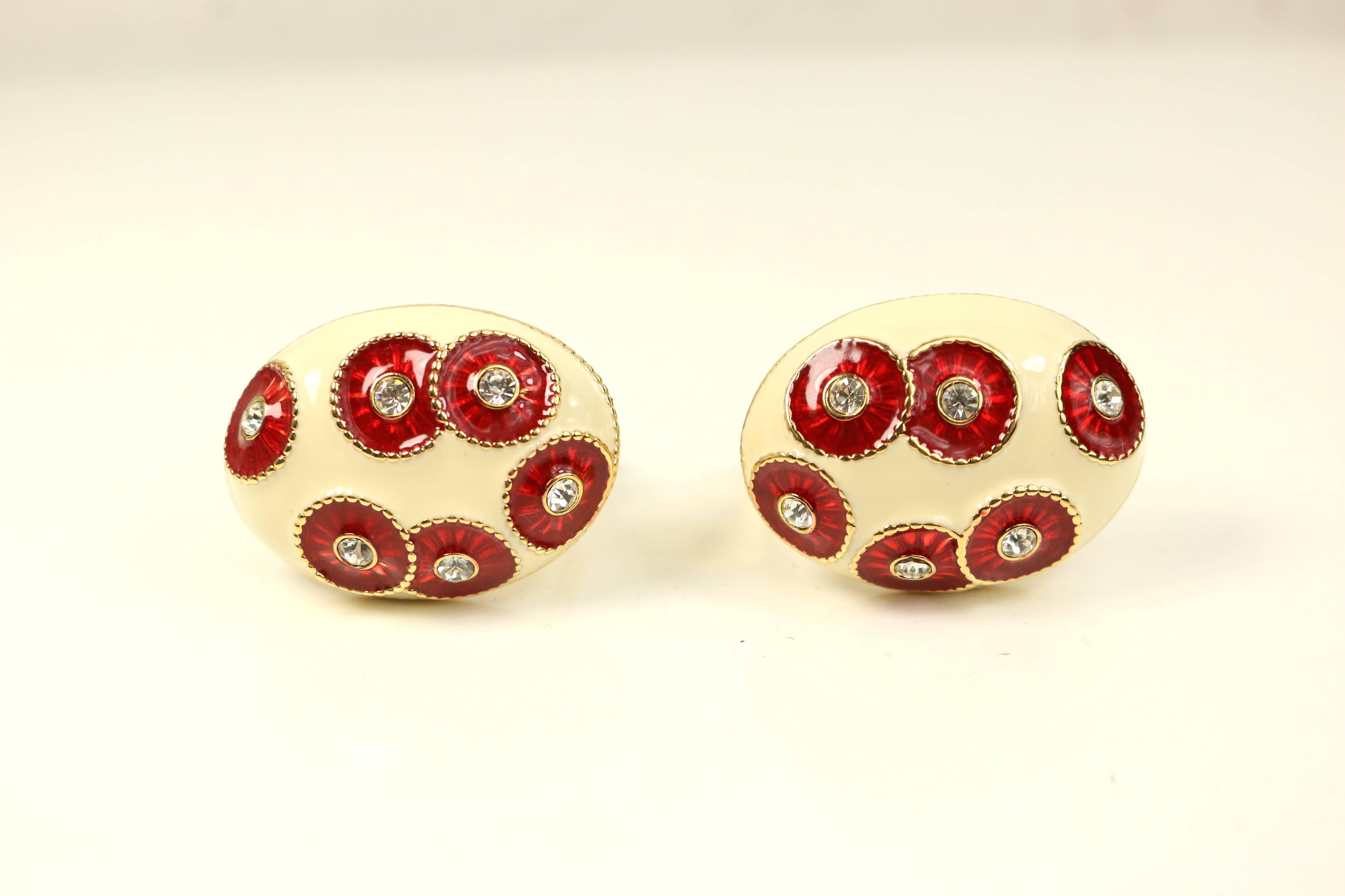 - Vintage 80s Nina Ricci gold toned setting Ivory red crystal rhinestones clip on earrings. 

- Featuring an oval shape. 

- Height: 1.5 inches. Width: 1.25 inches. 


