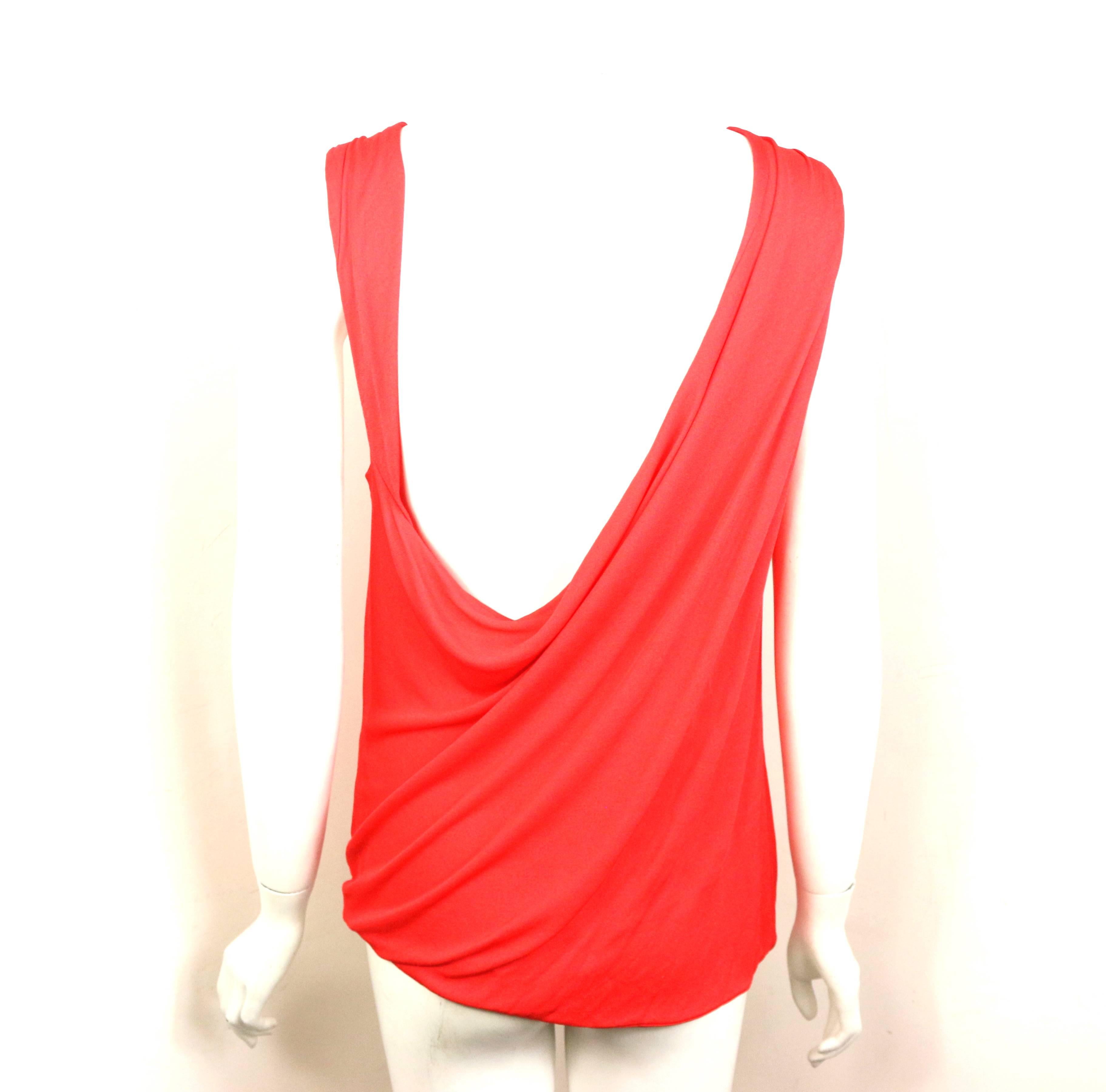 - Vintage 90s Gianni Versace Couture red rayon asymmetric and deep- v cutting at the back tank top. 

- It is his signature style which is definitely sexy with a sense of elegant style. 

- Size 42. 

- 100% Rayon. 


