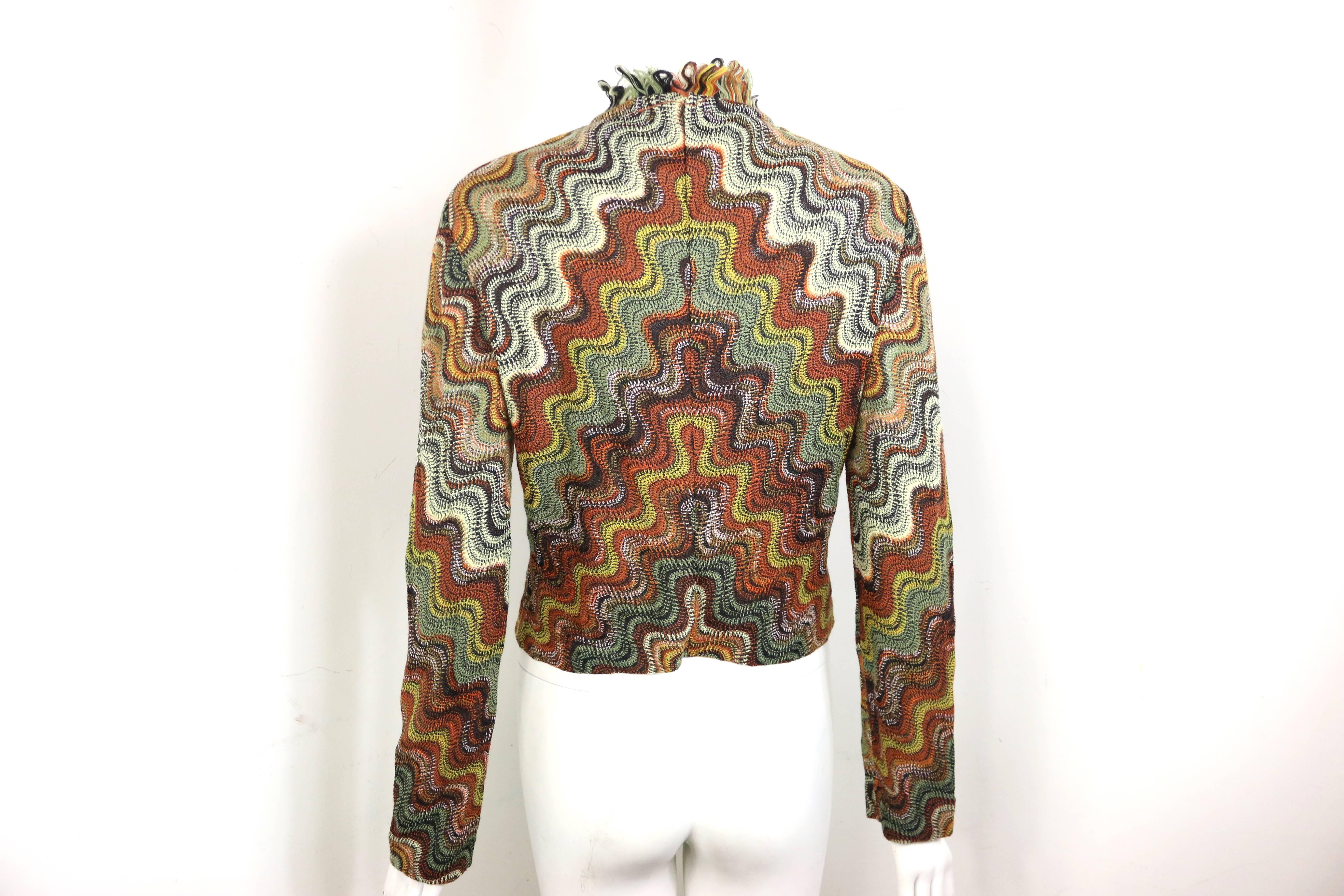 - Vintage 90s Missoni wool multi colours signature and iconic wave pattern cardigan jacket.

- Fringe trim in front. 

- Hooks fastening. 

- Size 42. 

- 54% Wool, 46% Rayon. 
