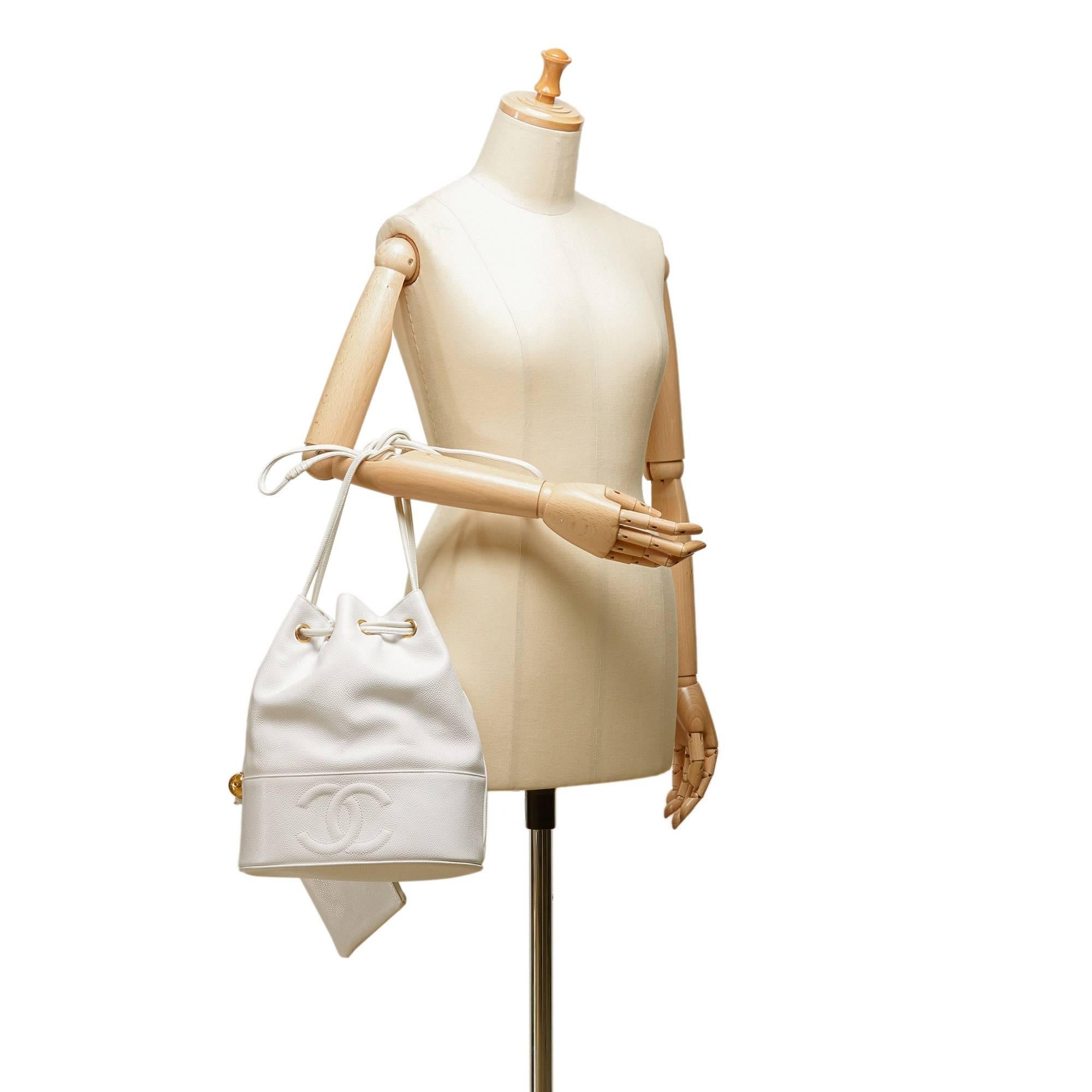 - Vintage 90s Chanel White Caviar leather drawstring shoulder bucket bag. 

- Round gold-toned 