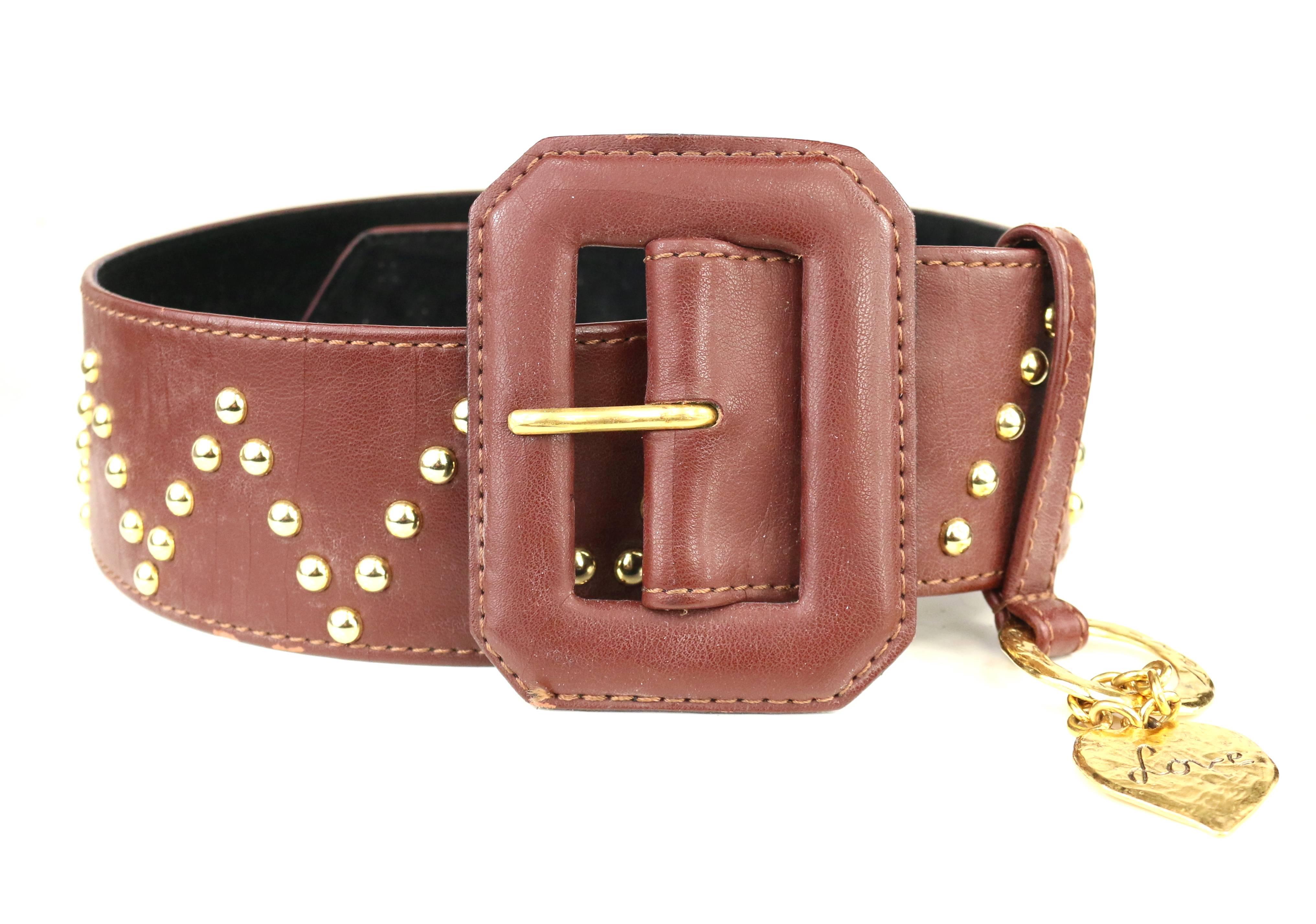 - Vintage Yves Saint Laurent brown leather with V shape gold-toned studs throughout the belt. 

- Featuring gold-toned heart shape hardware charm with 