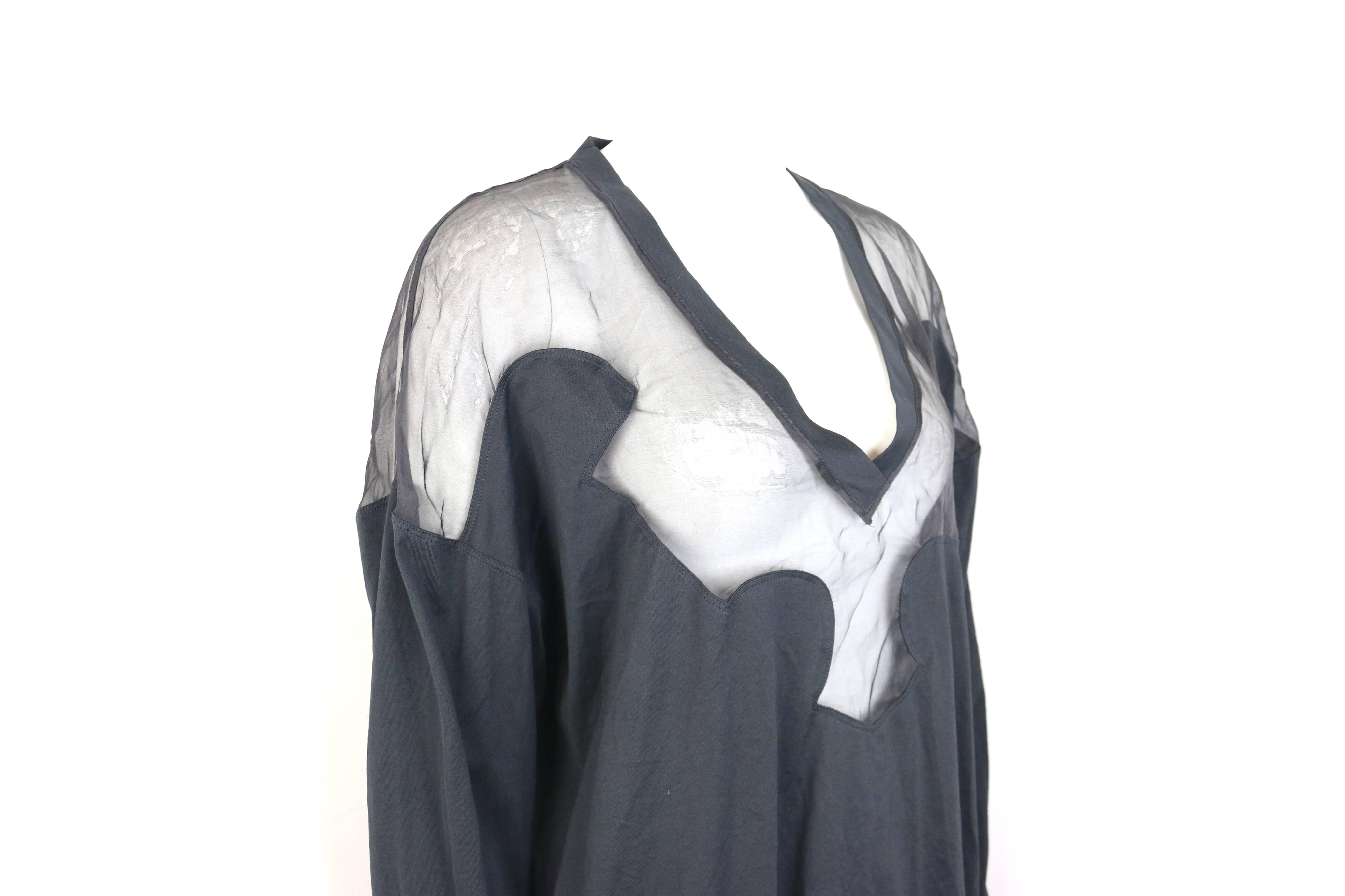 - Givenchy black cotton and silk long sleeves V-neck tunic top. 

- Featuring a transparent silk puzzle pattern and cotton body with cuff details. 

- Pullover top. 

- Size S. 

- 100% Cotton. 100% Silk. 

- Unworn with tags. 