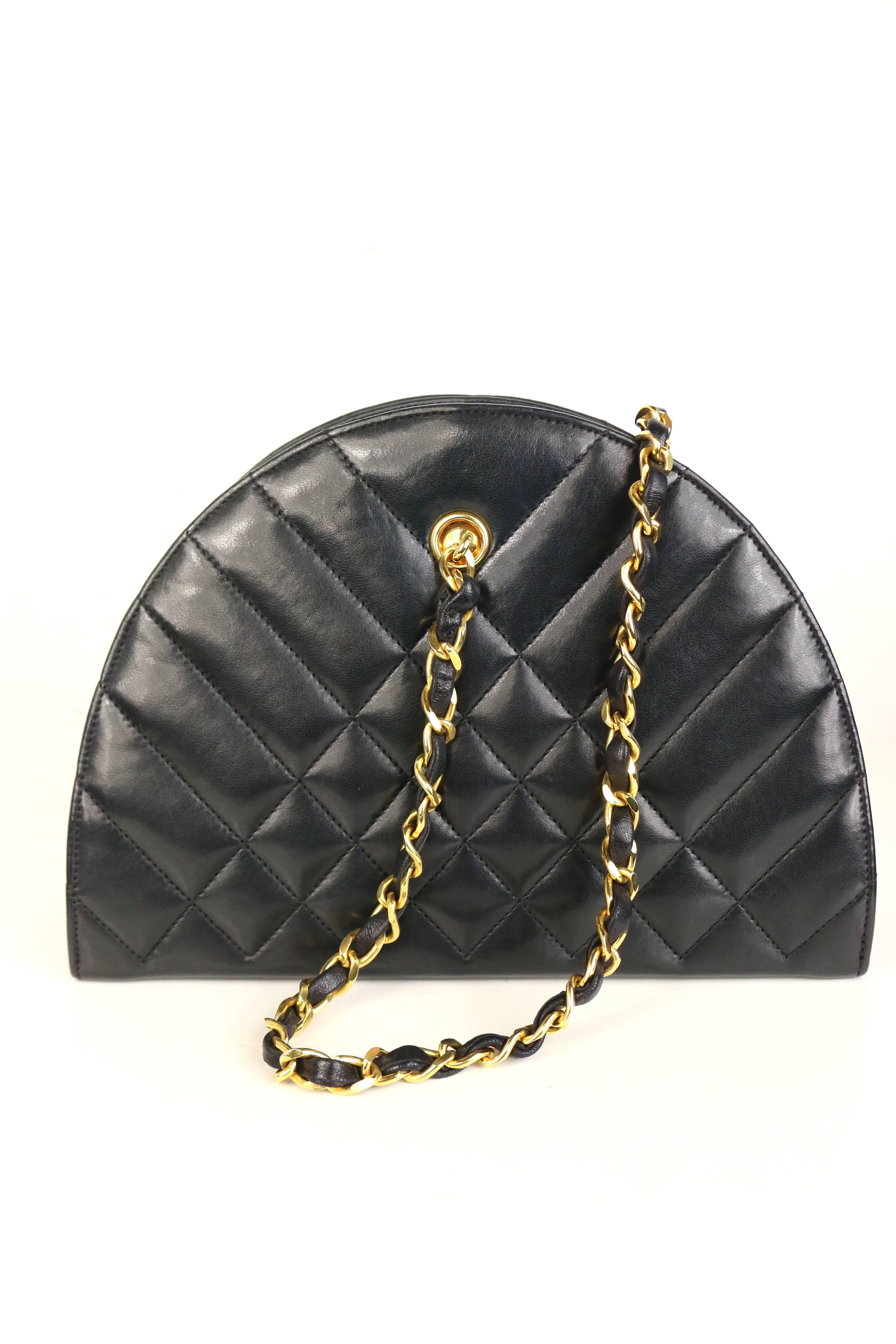 - Vintage 1989-1991 Chanel black half round lambskin leather quilted shoulder bag. You can carry it as a clutch as well. It is a really rare item!

- Featuring a top zip fastening, a chain shoulder strap and an internal slip pocket.  

- Serial No: