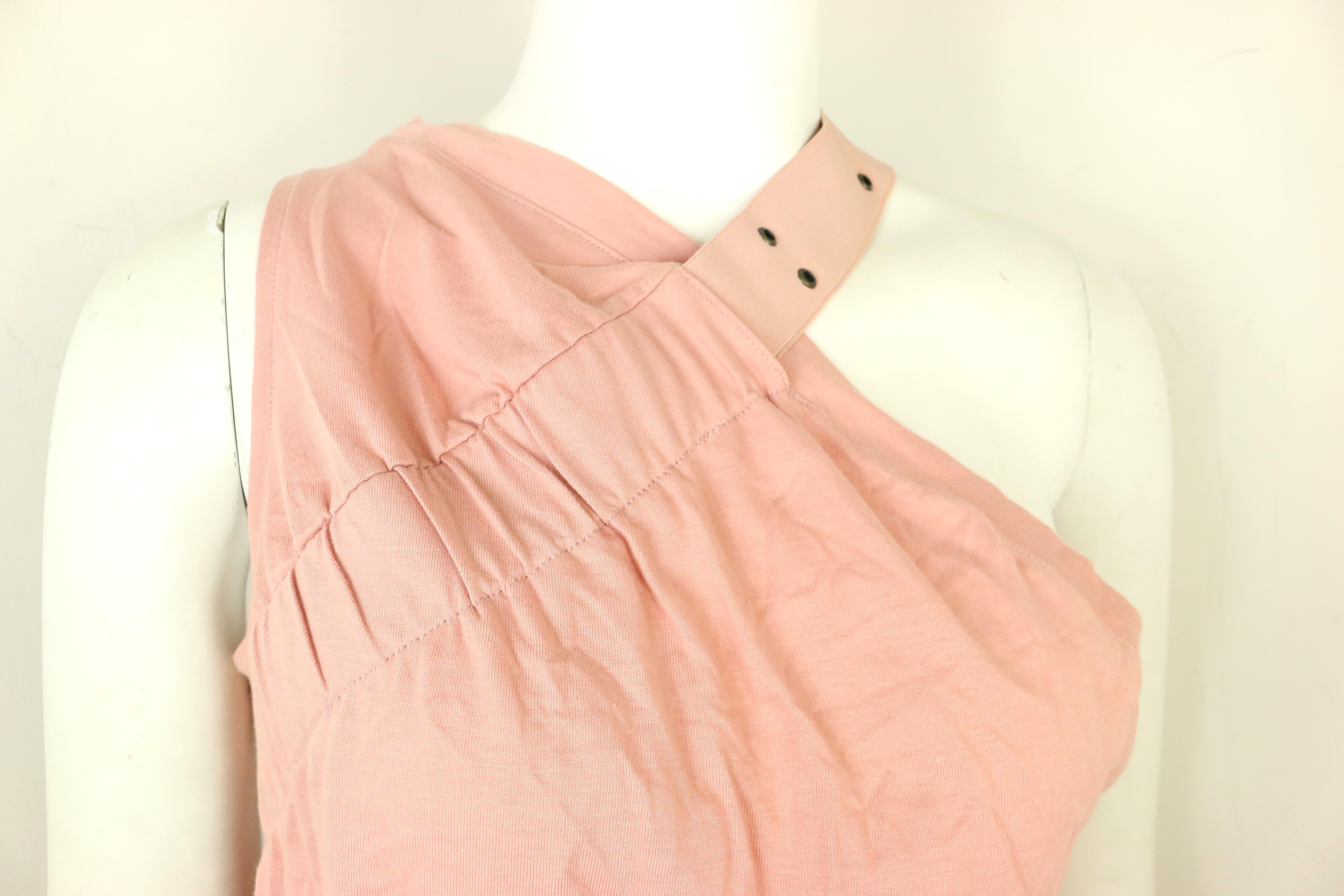 - Vintage 2000s Dior cotton pink tank top.

- Featuring an eyelet strap across the left shoulder to right bust. It has a lower armpit cut on the left side and higher on the right armpit. It's very deconstructed which is the signature design of John