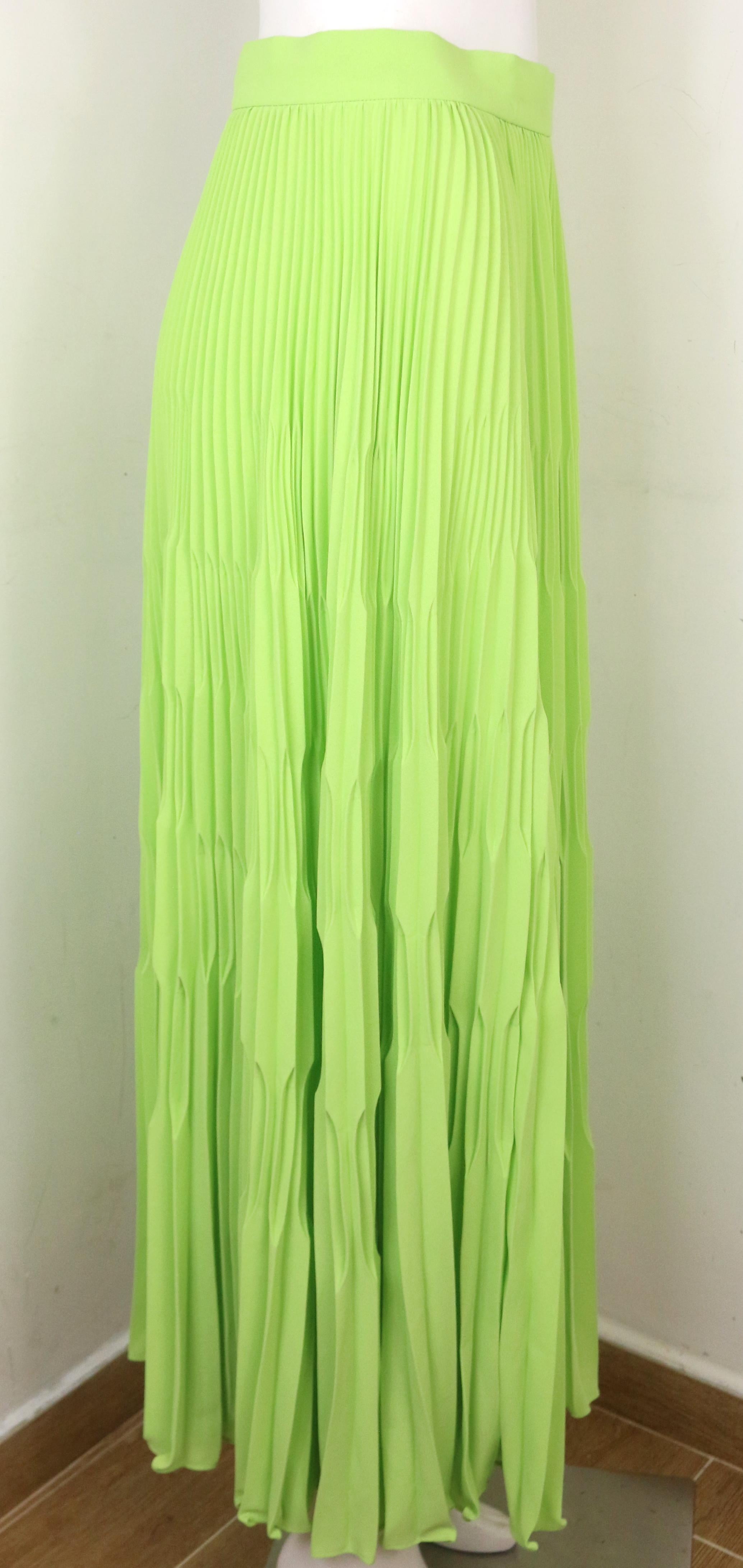 - Vintage 80s Escada green polyester pleated long skirt. Its a really bright and nice color. Pair it with a white t-shirt or top for a hot summer vacation. 

- Featuring side zip and button closure. 

- Size 36. 

- 100% Polyester. 

- Unworn with
