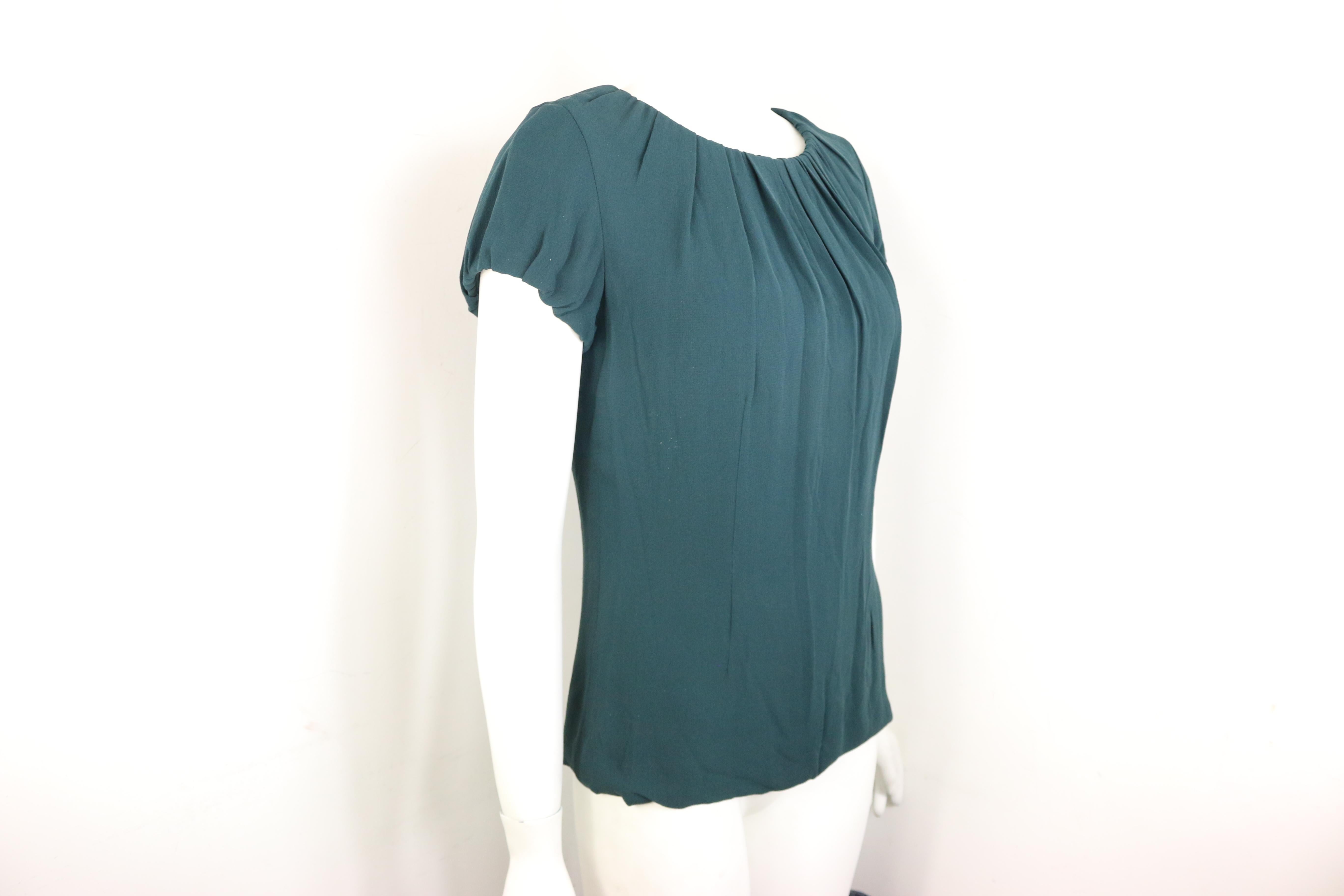 - Celine green silk short sleeves blouse. Inserted drawstring on the neckline and sleeves to create a flowy and pleated effect. 

- Featuring a side zip closure. Tiny hook fastening at the back with drawstrings attached. 

- Size 38. 

- 100% SIlk.