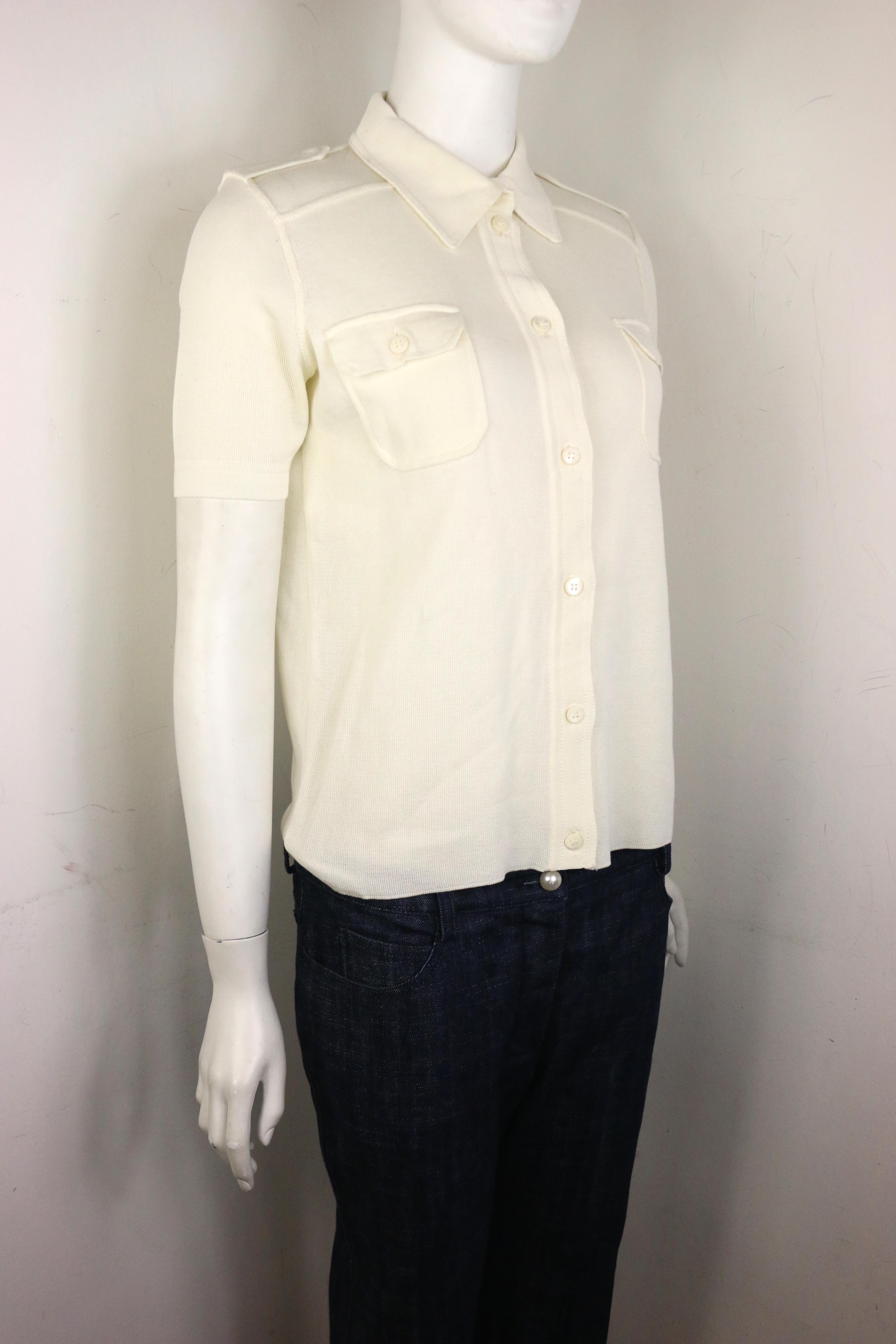 - Vintage 90s Prada white cotton knitted short sleeves collar shirt. The style is fitted. 

- Featuring shoulder epaulettes with button closure. Front buttons closure. Two front pockets with button closure. 

- Size 44. 

- 100% Cotton. 
