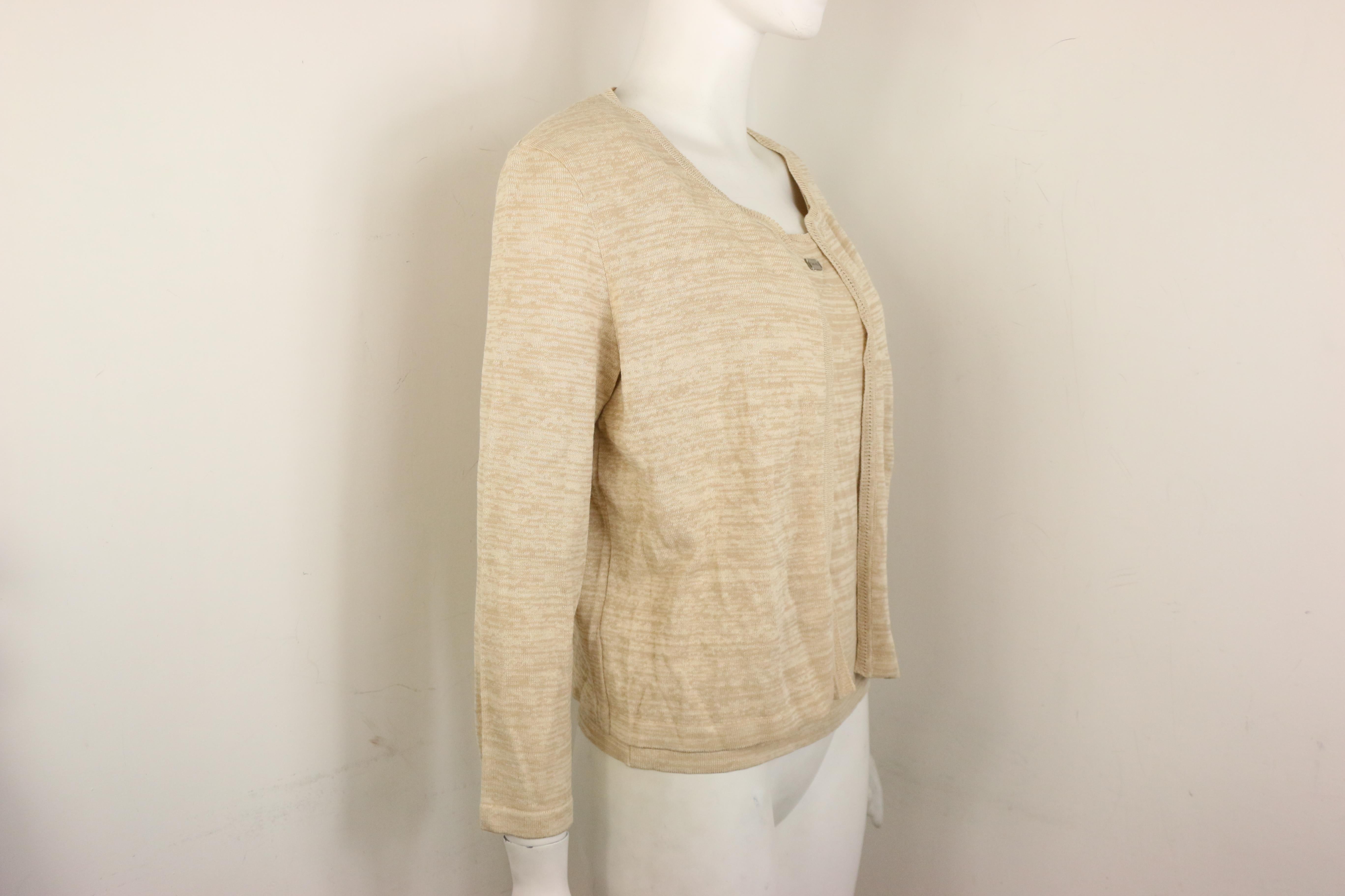 - Vintage Chanel beige cotton and rayon cardigan from spring 1999 collection. 

- No button closure. 

- Ribbed collar, hem, and cuff. 

- Size 40. 

- 50% Cotton. 45% Rayon. 5% Polyester. 