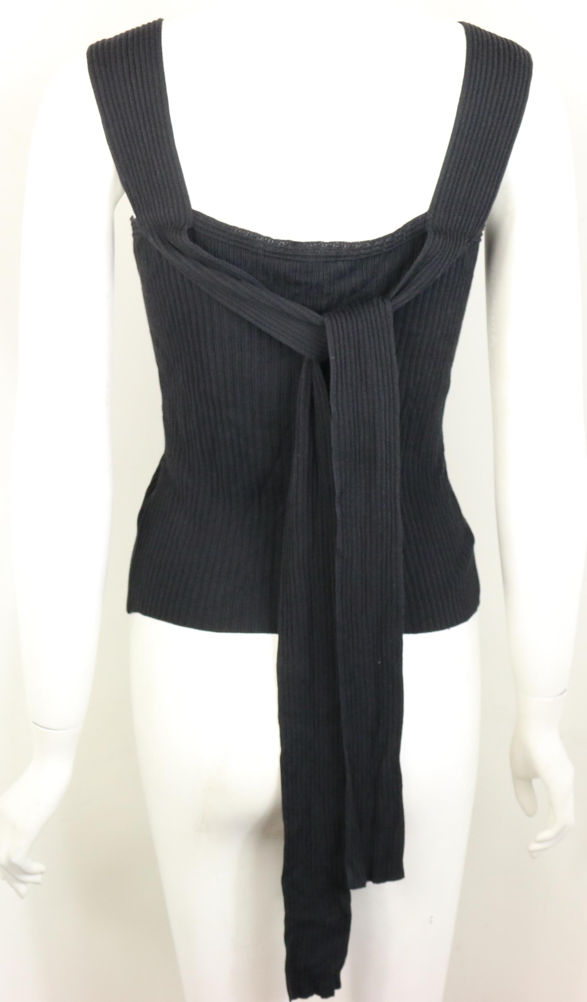- Vintage Chanel black knitted cotton and rayon sleeveless top from the year 1999 spring collection. 

- Featuring extended straps fabrics at the back. 

- Front slit hem. 

- Size 38. 

- 33% Cotton, 63% Rayon. 


