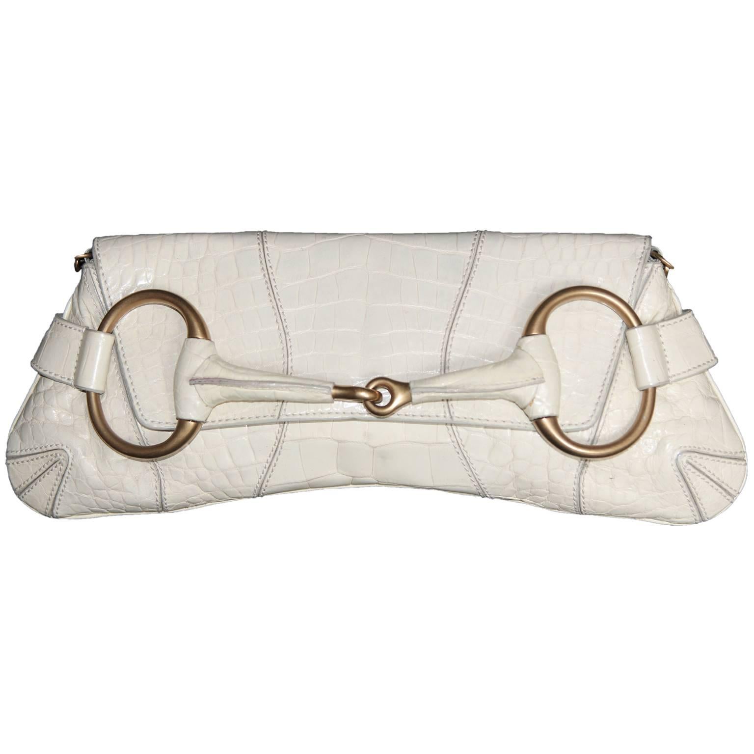 One of the most memorable Tom Ford for Gucci pieces of all... that ridiculously chic and incredibly rare Tom Ford for Gucci Fall Winter 2003 white croc gator crocodile alligator leather horsebit bag!

The Iconic Collections has been one of the