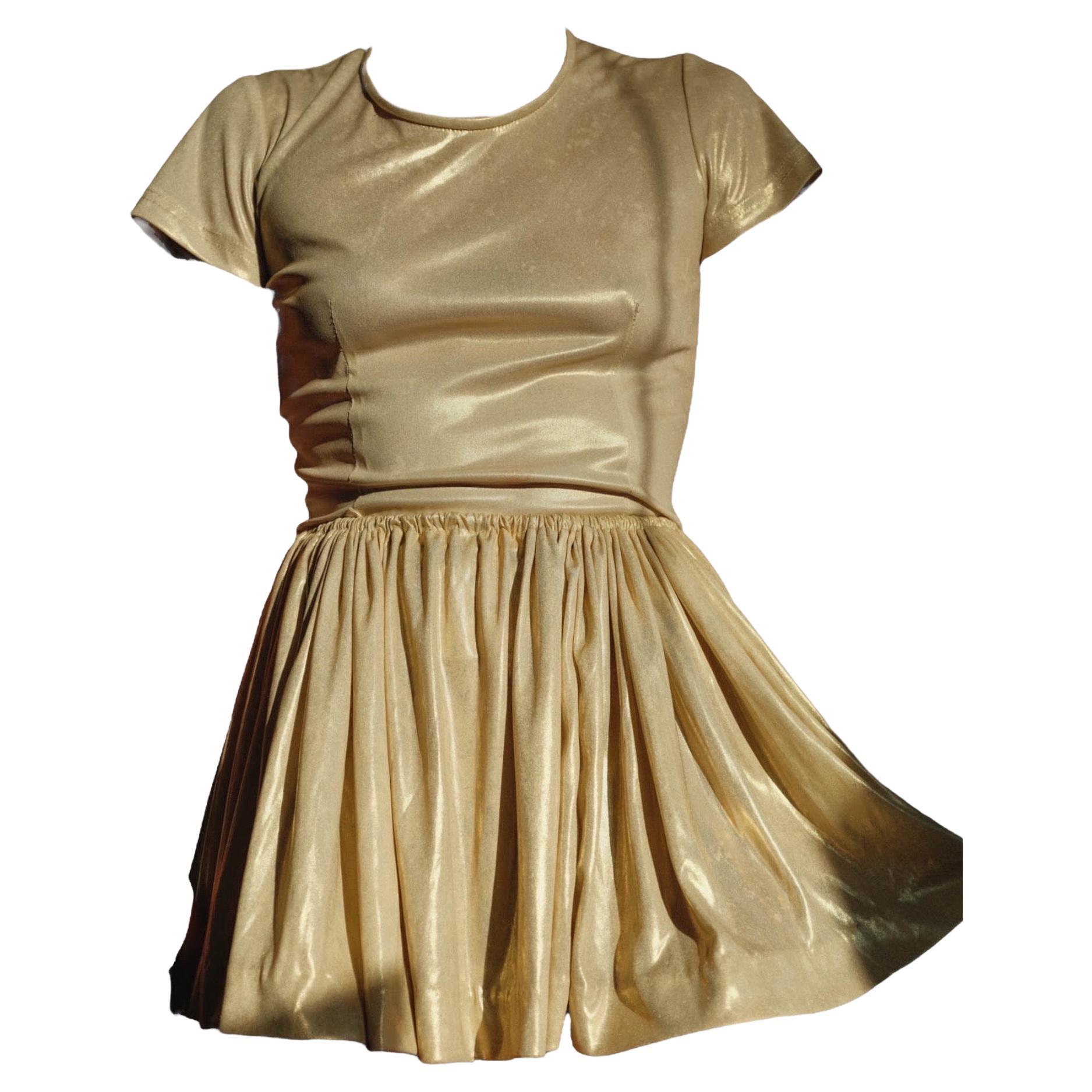 1988 SS Pagan Collection Vivienne Westwood Gold Mini Skirt ensemble 
Short sleeve T-shirt and Ruffle miniskirt 
Absolute show stopper piece 
Archival collectors item

OK vintage condition, moderate to heavy wear to be expected of used item this age