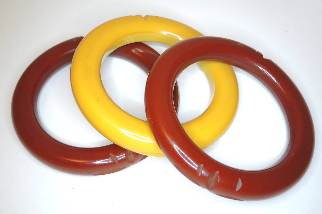 Here we have three carved bakelite bangles in butterscotch and caramel brown.  Each of these bangles measures 8 ¼” around the inside x ½” and they are all in excellent condition.