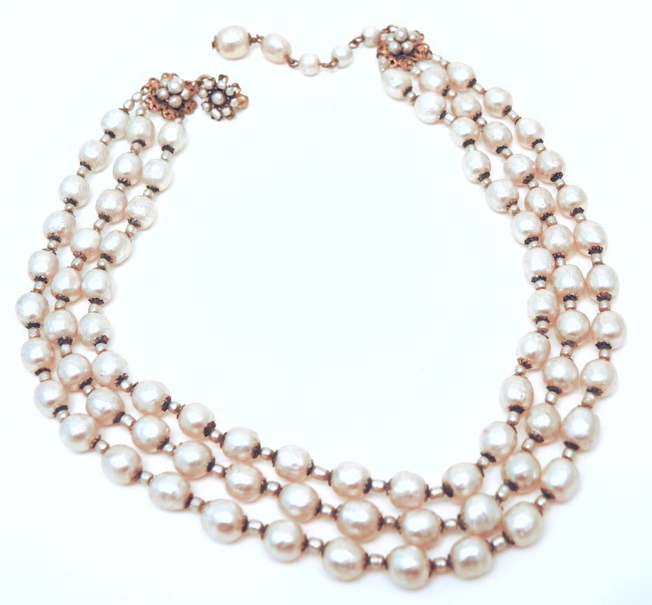 We are always looking for three strand pearl Haskell but they are very hard to come by.  This vintage signed Miriam Haskell necklace features 3 strands of baroque faux pearls in a gold-tone setting.  This necklace measures 16” with a hook closure;
