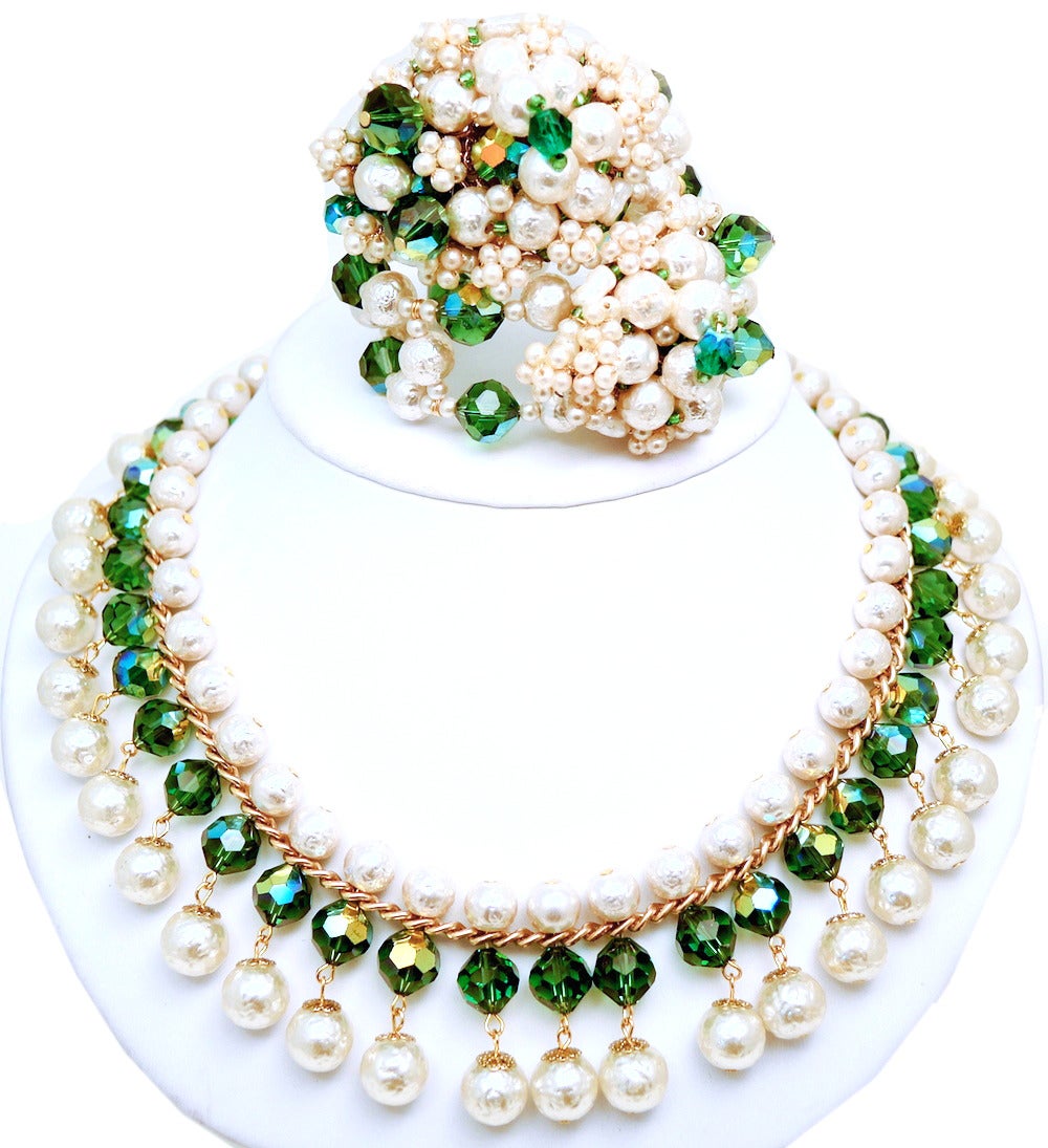 This set has been in a superb collection and has come to us in mint condition.  Fabulous and rare Hobe faux pearl and bezel cut green glass bead necklace & wrap bracelet in a gold-tone setting.  The necklace measures 17” x 1 1/4” with a push/in