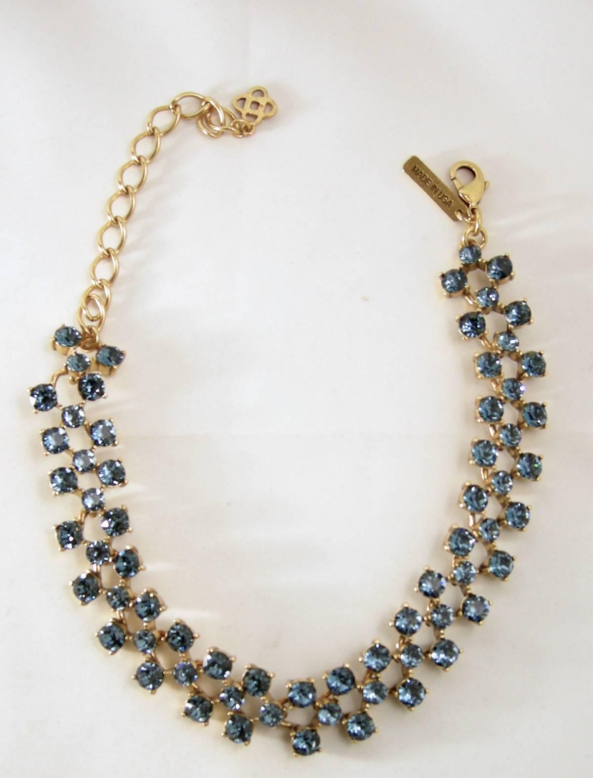 This is an outstanding set and is a classic showstopper. This Vintage Oscar De La Renta necklace features 3 rows of all blue sparkling rhinestones in a gold tone setting.  It measures 18” x 3/8” while the matching clip rhinestone drop earrings