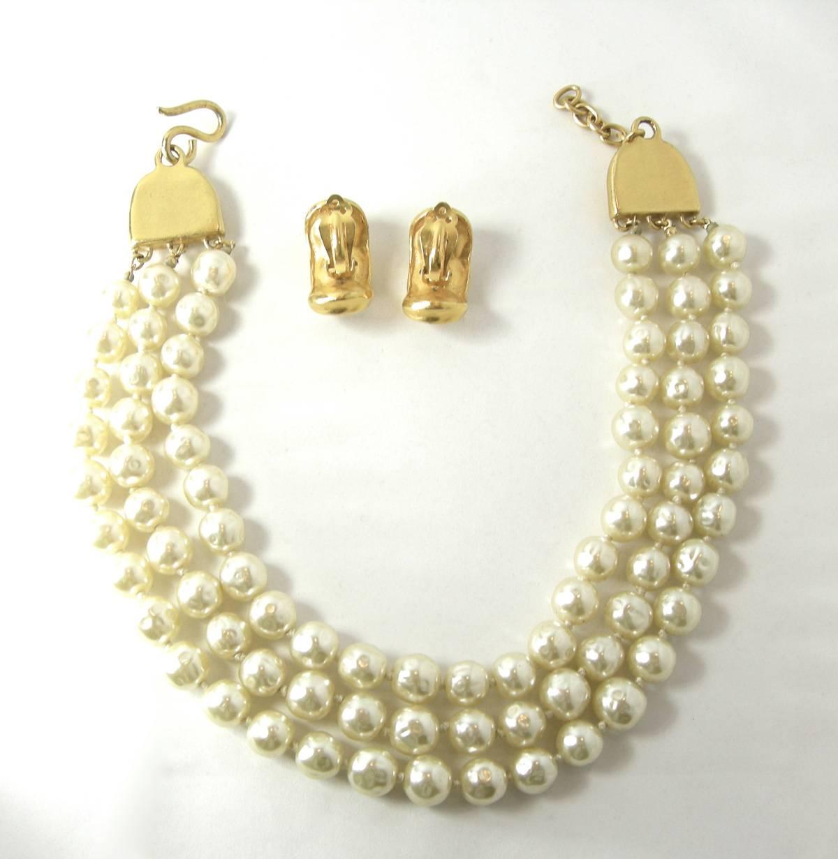 Pearls are back and what better way to celebrate them is with this Robert Lee Morris faux baroque pearl necklace and earrings set.  I bought it from a collector of Robert Lee Morris     There are 3 strands of large pearls.  Each end has a gold tone