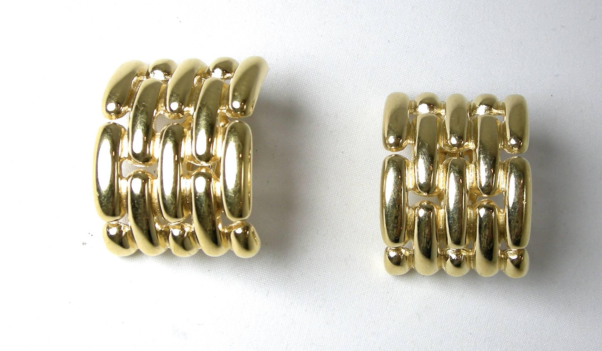 These beautiful 1990s Givenchy clip-back earrings have a ribbed design in a gold-tone setting.  They measure 2-1/4” x 7/8” and signed “Givenchy Paris New York”.  They are in excellent condition.