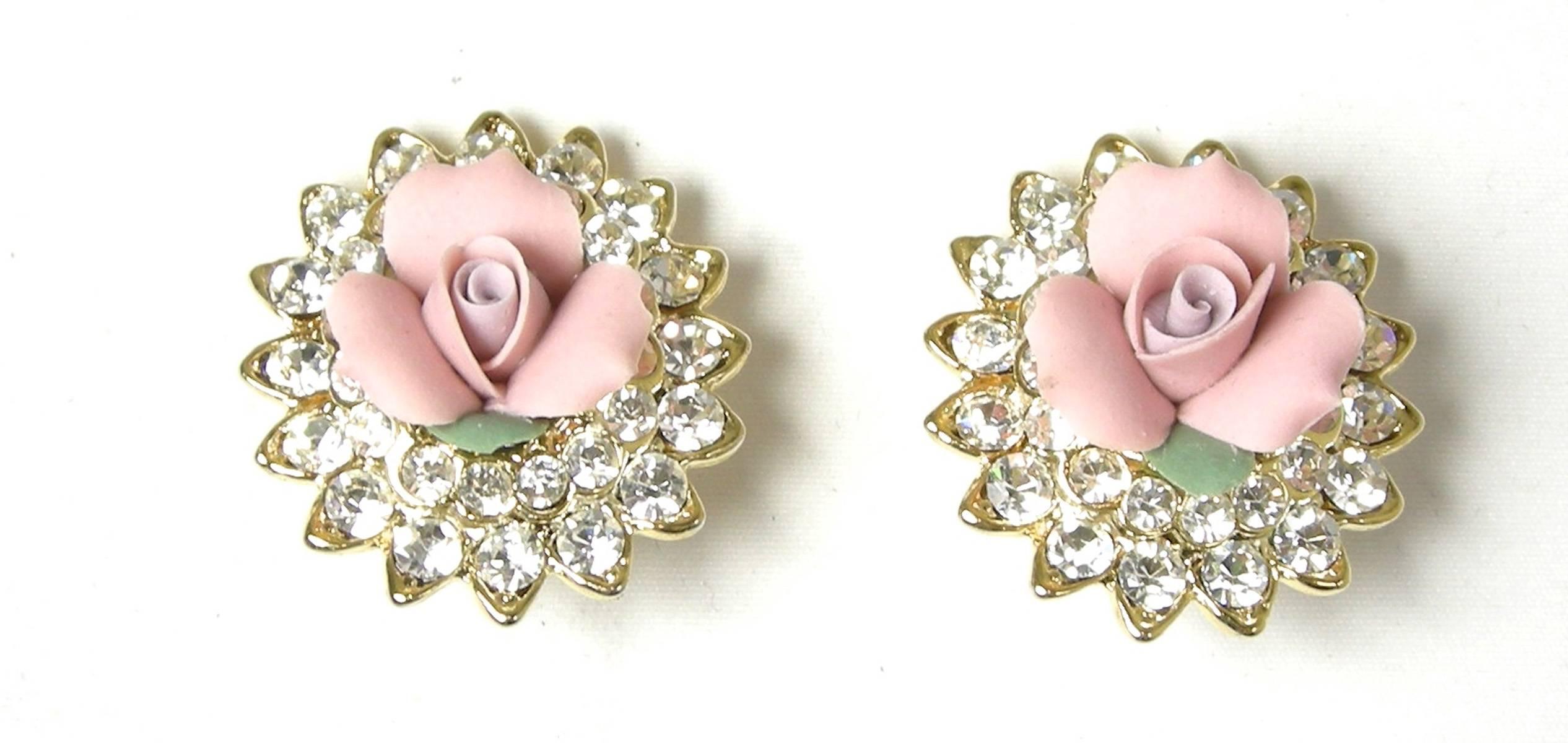 These signed Kenneth Jay Lane earrings have beautiful vibrant crystals and are made with pink carved resin flower centers. These clip-back earrings are set in a gold-tone setting and measure 1” x 1”. They are signed “Kenneth Lane” and are in