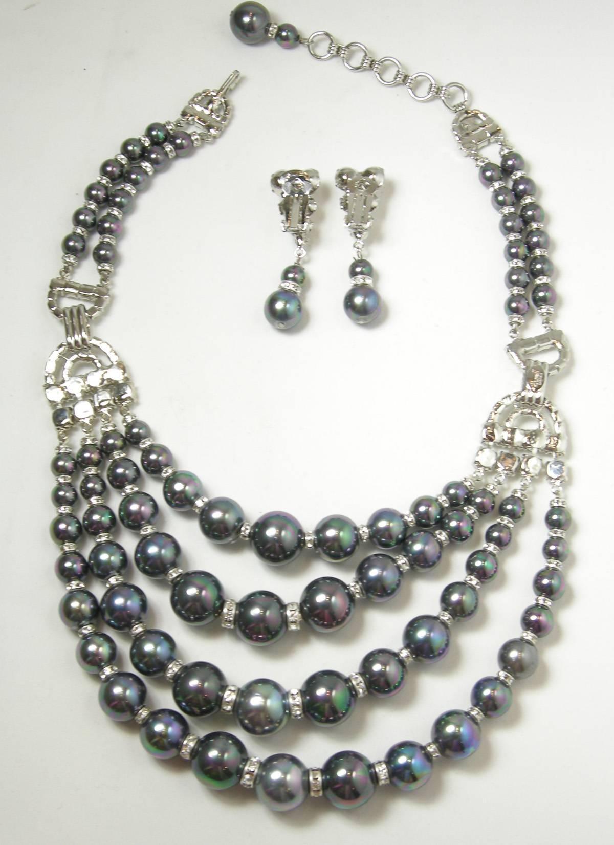 This is a one-of-a-kind Robert Sorrell creation.  It is a bib necklace made with faux Tahitian pearls and crystals in a rhodium silver tone finish.  There are four rows of the Tahitian pearls that graduate in size with crystals in-between.  The