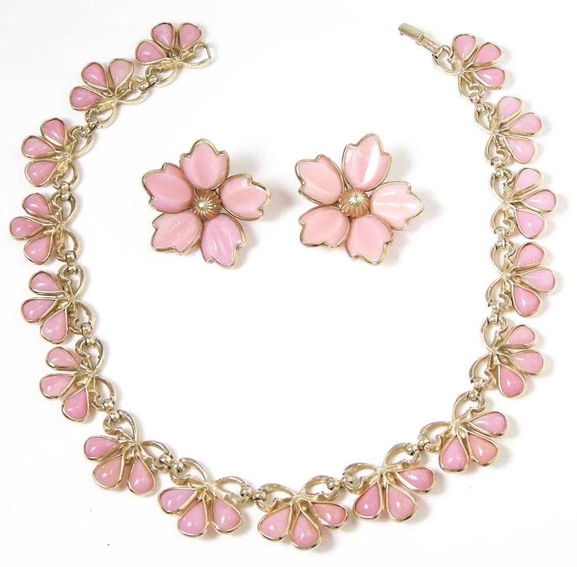 Once in a while you find something special like this 1940s Trifari pink poured glass floral necklace set.  Each piece is moulded glass creating a floral necklace and matching clip-back earrings.  It’s in a gold tone setting.  The necklace is 15-1/2”